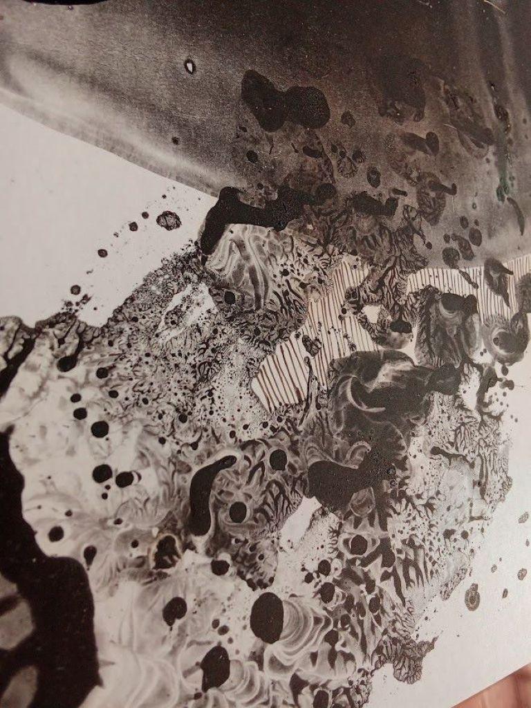 This artwork is an enigmatic abstract creation that skillfully blends fluid, evocative forms with striking monochrome contrasts. The composition's upper section features a dark, dripping shape resembling ink splatters, suggestive of a shadowy crown