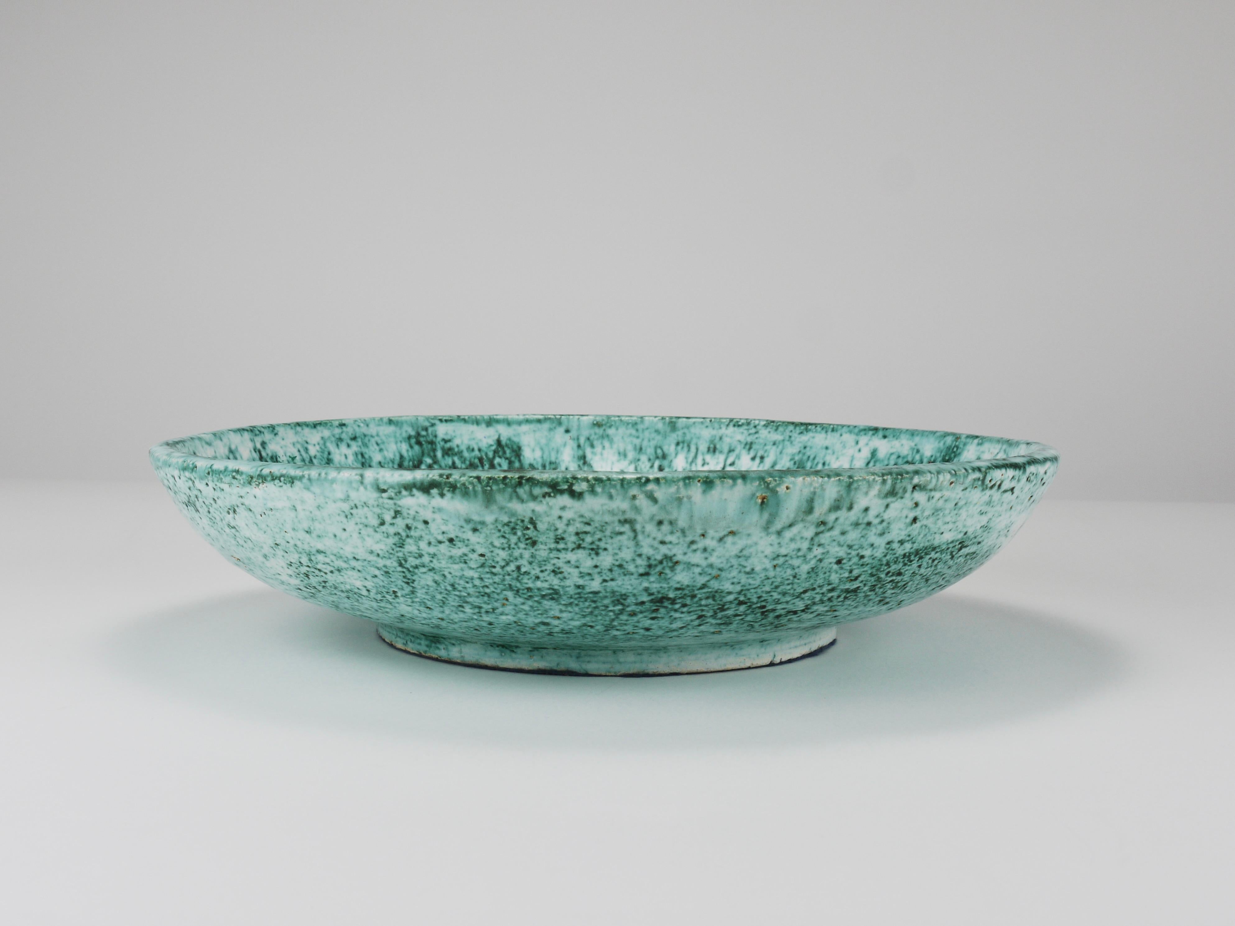 This is a beautiful, large decorative ceramic pottery bowl from the 1980s, designed and handcrafted in Italy by Eva Ruffoni. The bowl features a beautifully textured glaze with a speckled turquoise/greenish and white finish. It's a generously sized