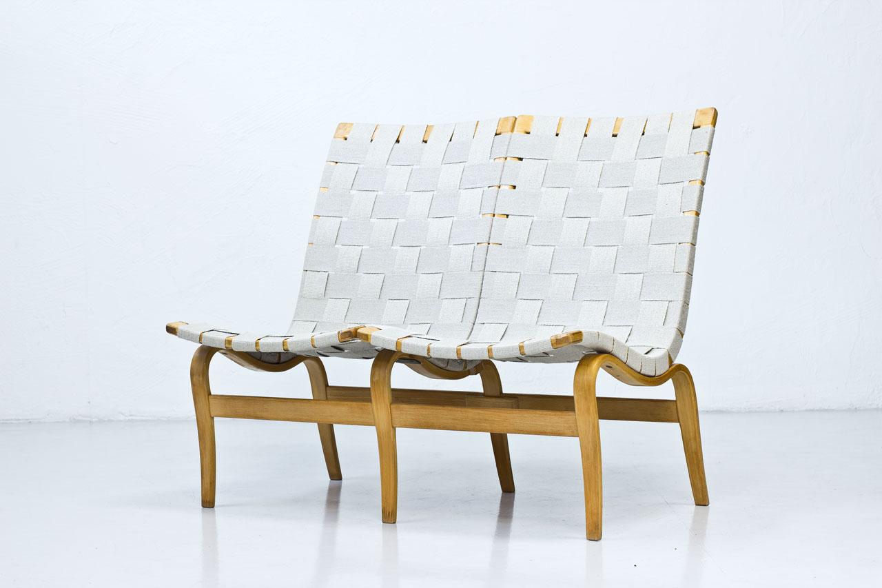 Two-seat “EVA” sofa designed by Bruno Mathsson. Produced by Firma Karl Mathsson in Värnamo, Sweden, dated 1969. Lacquered birch and beech with later linen webbing.