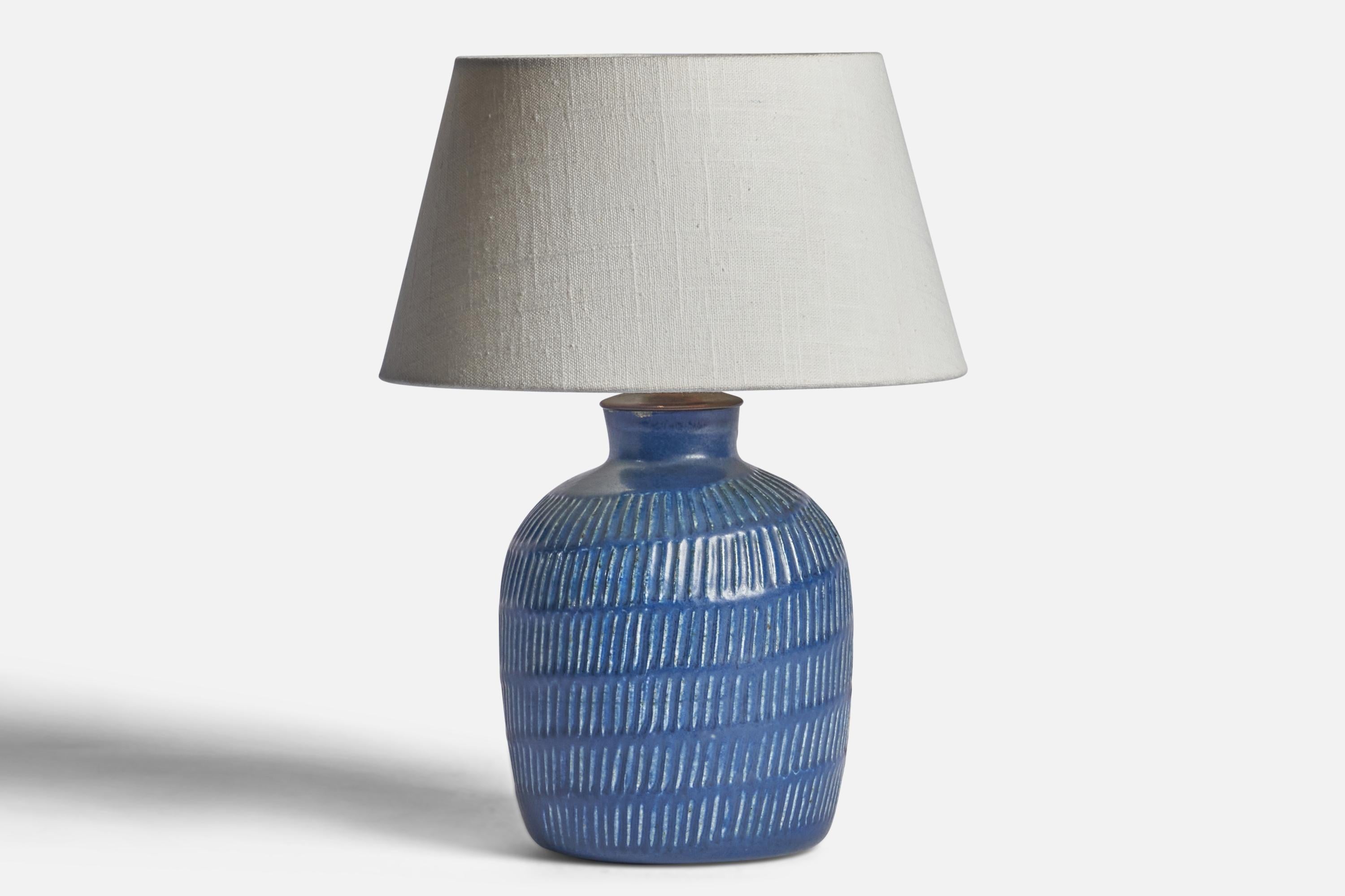 
A blue-glazed incised stoneware and brass table lamp designed by Eva Staehr Nielsen and produced by Saxbo, Denmark, 1950s.
Dimensions of Lamp (inches): 10.5” H x 5.75” Diameter
Dimensions of Shade (inches): 7” Top Diameter x 10” Bottom Diameter x