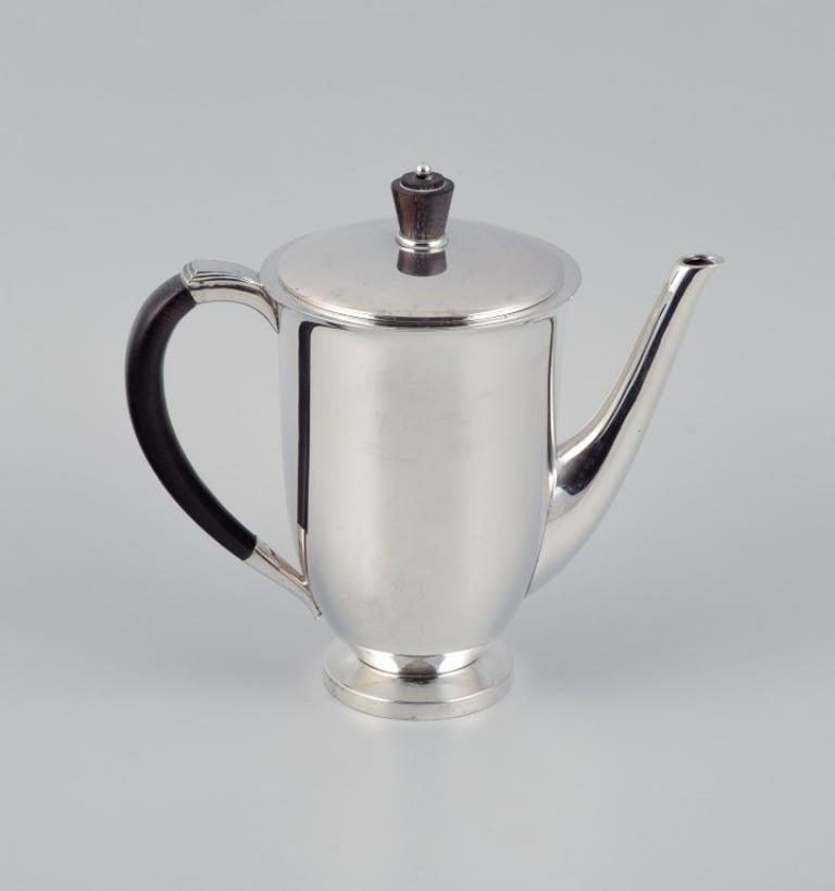 Evald Nielsen, coffee pot in Danish 830 silver and ebony.
1938.
Model 608.
In very good condition, with a minor crack in the wooden handle.
Marked.
Dimensions: H 17.5 x D 18.0 (including handle and spout.)





