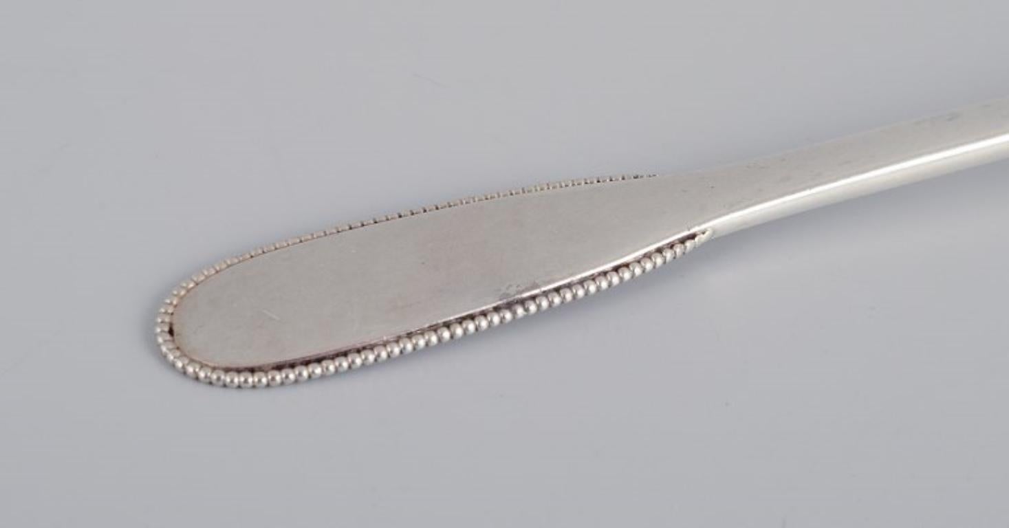 Early 20th Century Evald Nielsen, Danish Silversmith, Two Hammered Sugar Spoons in 830 Silver For Sale