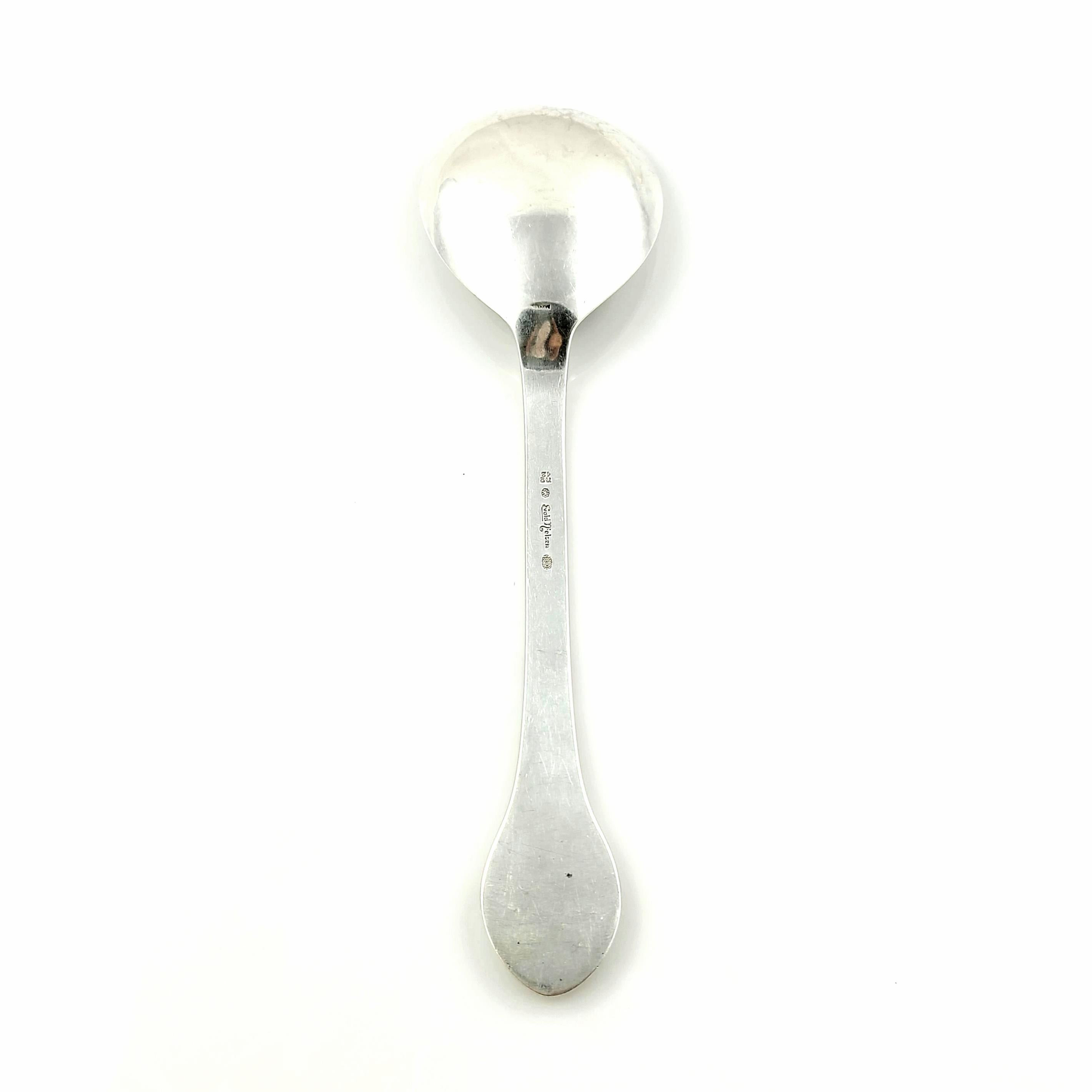 Vintage 830 silver serving spoon designed by Evald Nielsen of Denmark in the no. 12 blossom pattern.

Respected Danish silversmith, Evald Nielsen, designed all his own patterns. Pattern no. 12, blossom, is one of his earlier patterns, and features