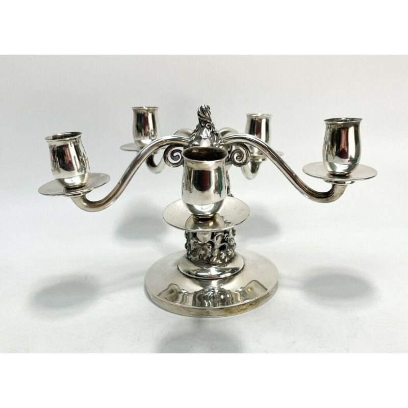Evald Nielsen for Johannes Siggard sterling silver candelabra, 1934

A sterling silver candelabra, beautifully executed in a fruiting grape vine motif with five arms, Evald Nielsen for Johannes Siggard. 1934. Impressed three tower sterling mark,