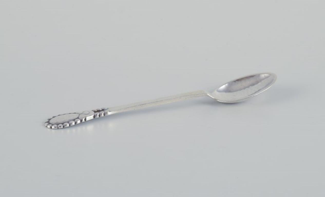 Evald Nielsen No 13.
A set of eleven coffee spoons in 830 silver.
Hammered finish.
Dated 1925.
Hallmarked.
In perfect condition.
Dimensions: Length 11.2 cm.