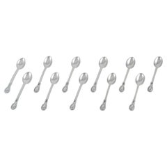 Antique Evald Nielsen, set of eleven coffee spoons in 830 silver.