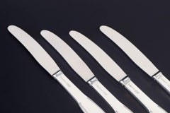 Evald Nielsen. Lot de quatre couteaux de table en argent massif et en acier inoxydable