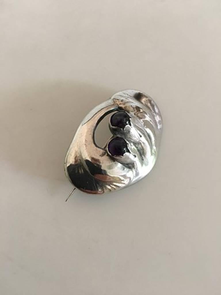 Evald Nielsen Silver Brooch with Amethyst. Measures 4 cm L (1 37/64 in). The stones have some wear but otherwise in good condition. Weighs 9 grams.