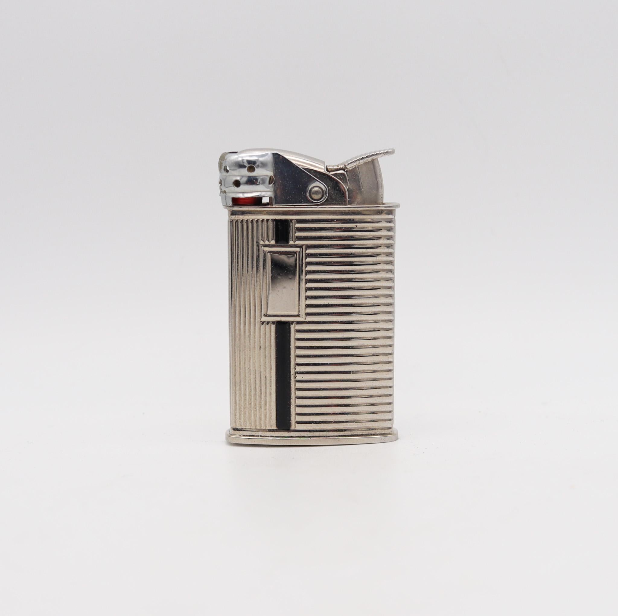 Spitfire pocket lighter designed by Evans.

Rare automatic spitfire pocket lighter, created in America by the Evans Company, back in the 1940. This very handsome piece has been crafted with deco-modernist patterns in chromed steel with accents