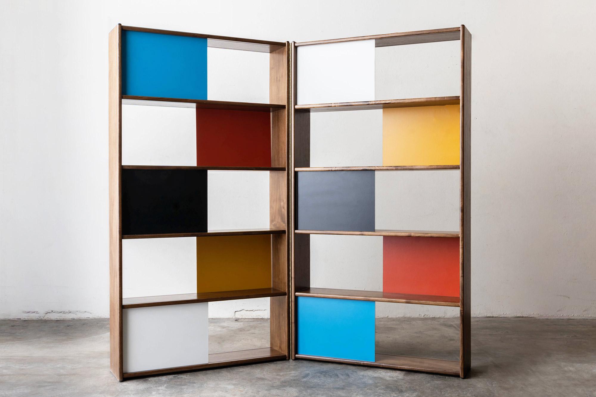 Walnut, colored masonite and brass bookcase/room divider designed by Evans Clark for Glenn of California. Sliding Mondrian style colored panels and a 60