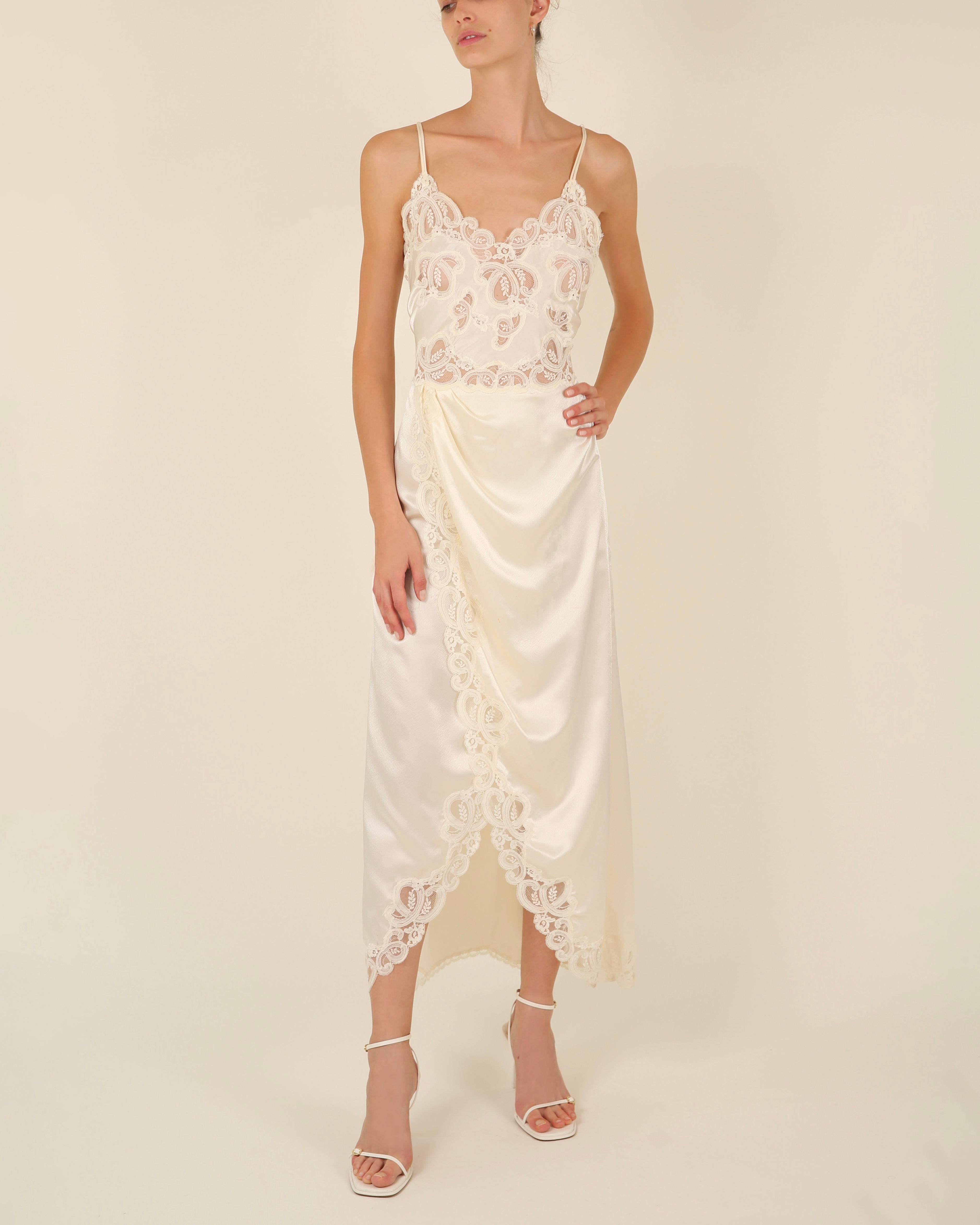 Eve Stillman Couture vintage lace night gown in silk. I would guess this to be from the 70's. It would work just beautifully for a wedding or worn in an evening
Ivory / cream
Spaghetti straps
Lace trim
Beautiful cross over skirt creates a beautiful