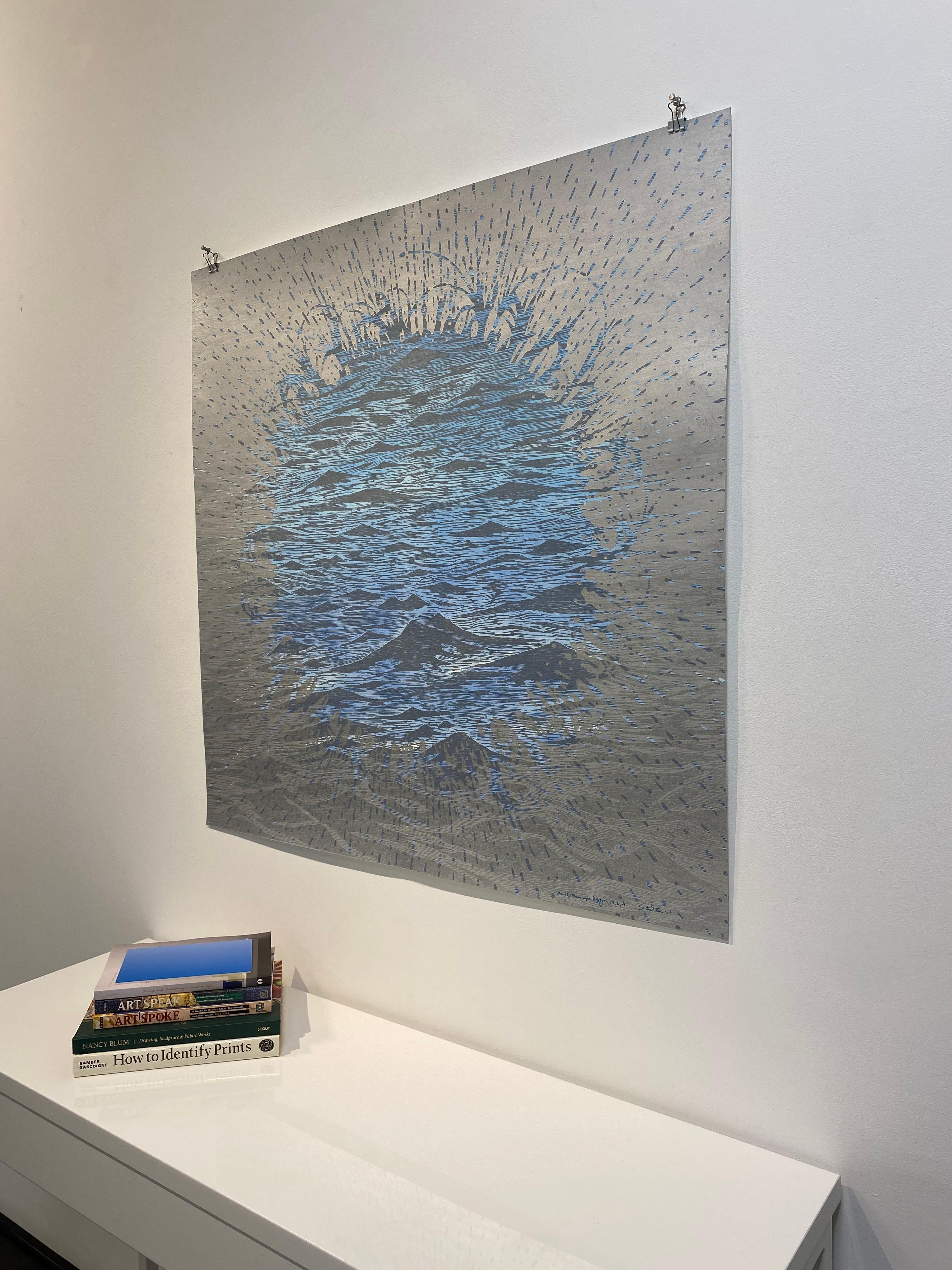 This horizontal diptych of two woodcut prints on paper evokes the peacefulness of ocean waves in alternating shades of blue and silver in metallic and colored inks with watercolor on paper. A central burst shape is the focal point of either side,