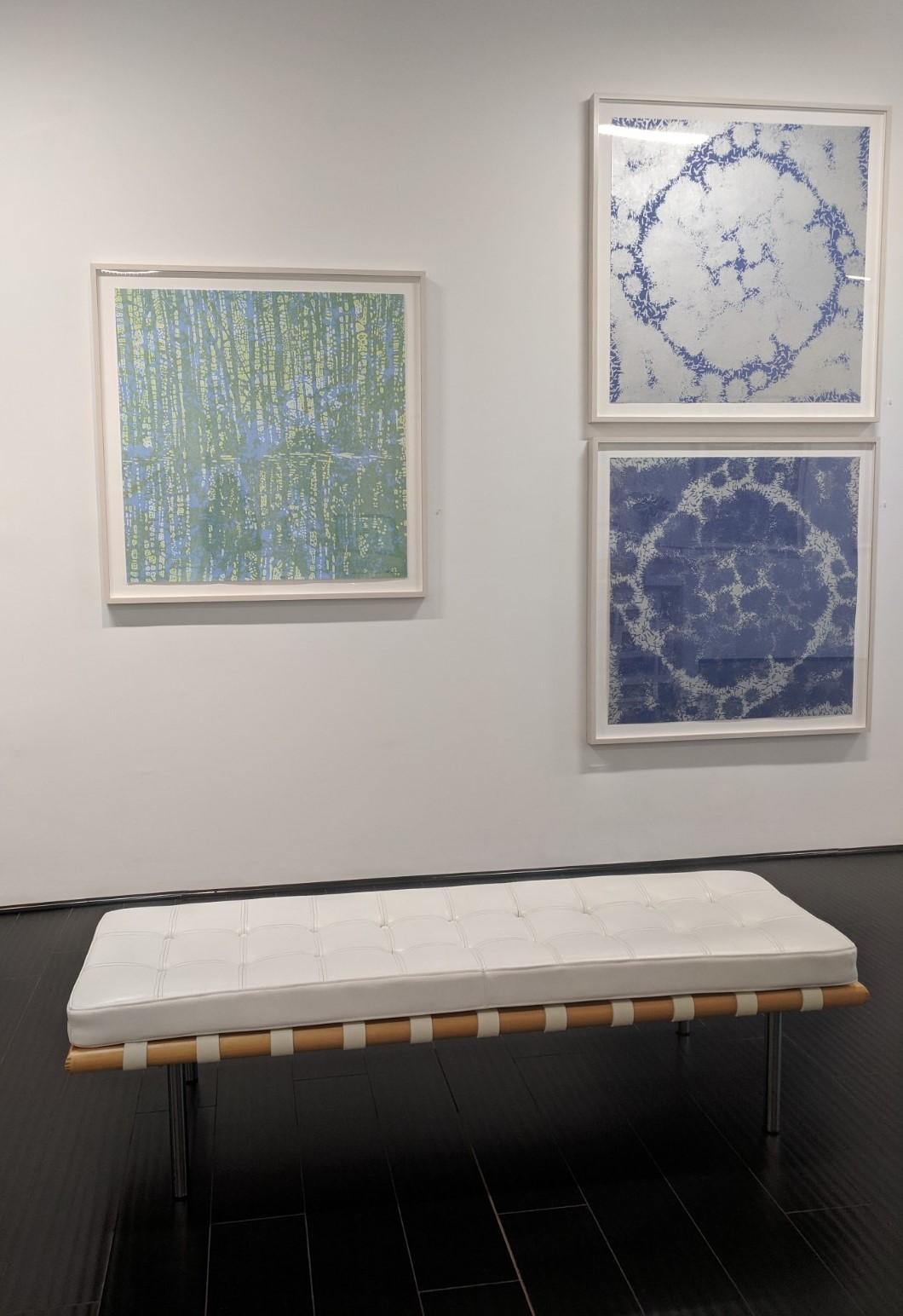 This square woodcut print on paper is composed of an abstract pattern of clustered dark navy blue shapes over a silver background with a subtle metallic sheen. The monotype brings to mind the tradition of Japanese printing while being distinctly