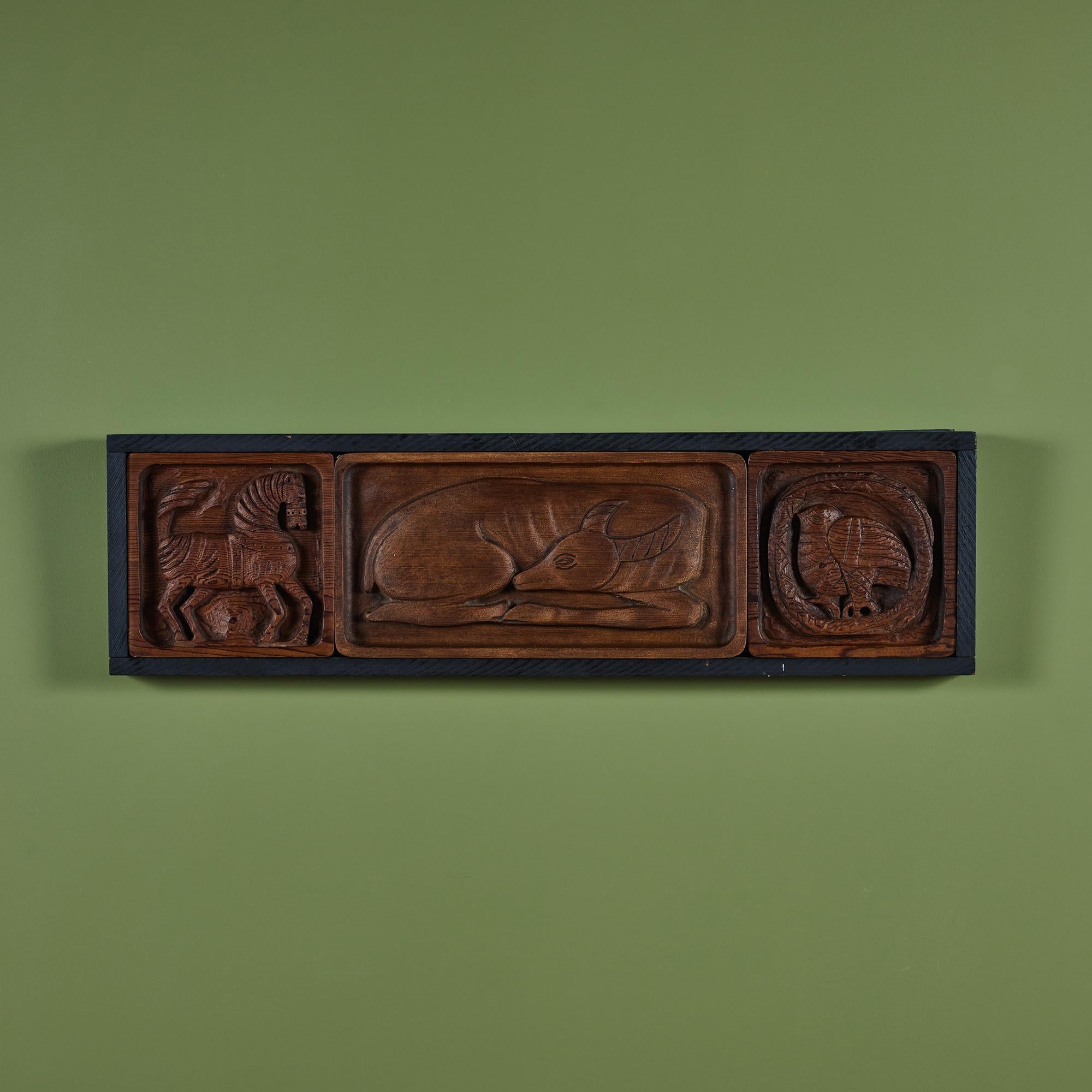 Wood carving by California artist, Evelyn Ackerman, c.1960s. This carving features three animals, a zebra, an antelope and an owl in a rectangular ebonized wood frame.

Dimensions 
40