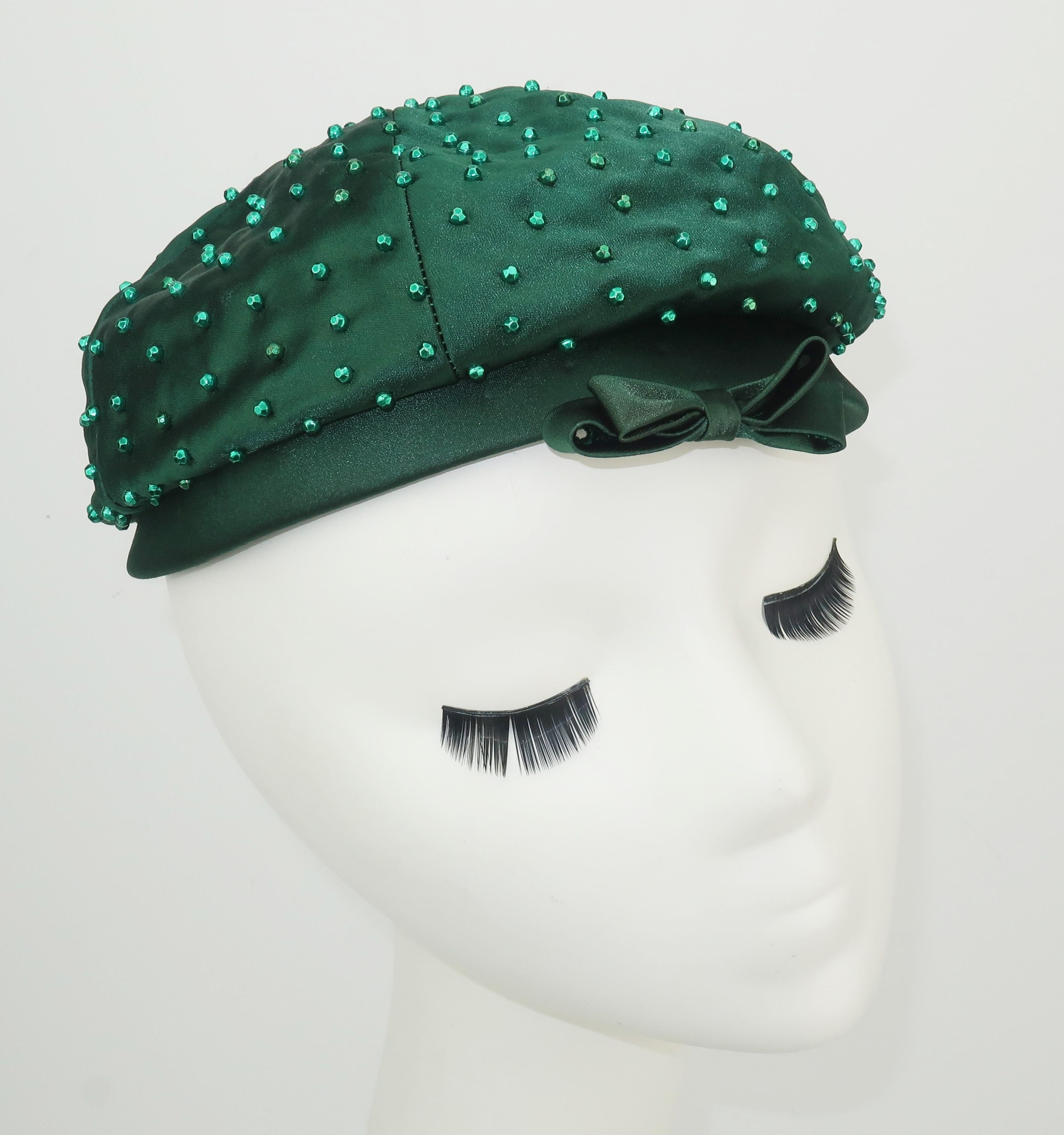A 1950's Evelyn Varon tam style hat in a rich hunter green satin embellished with faceted beads and a bow.  Perfect for adding glamour to day wear or a topper for evening.  Very good condition ... appears rarely worn.
MEASUREMENTS
The inside rim