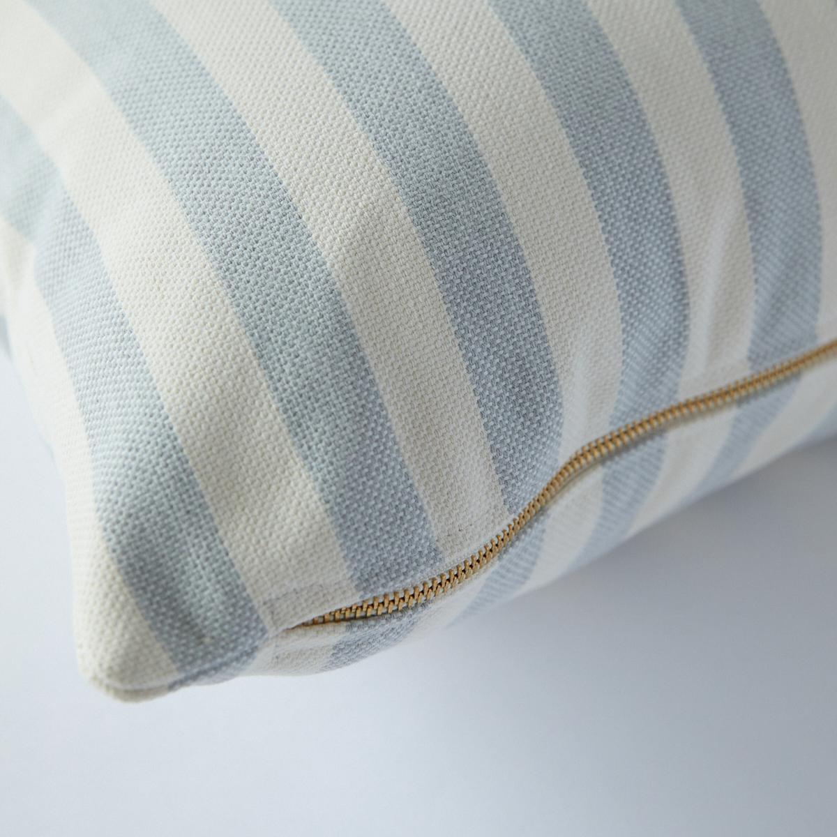 This pillow features Even Stripe Indoor/Outdoor by Caroline Z Hurley with a knife edge finish. We looked to our favorite artists like Agnes Martin and Louise Bourgeois as inspiration for this bolster pillow. A perfect medium stripe rendered in a