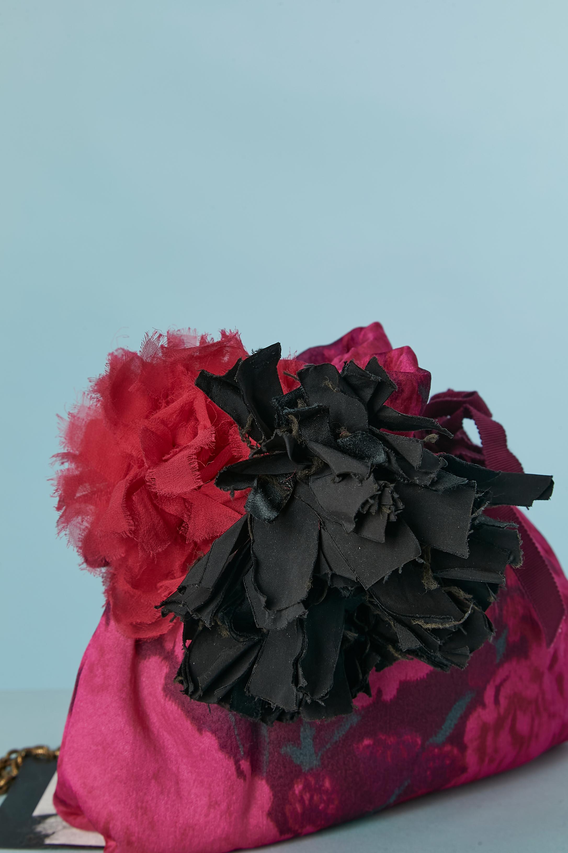 Lightly padded evening bag in printed fabric and Tie &Dye with fabric flowers embellishment. 
Gros-grain drawstring closure. One flat pocket inside. Red fabric lining ( probably rayon) 
Dust-bag provided. 
SIZE 25cm X 20cm X 3cm 
Chain lenght: 100cm