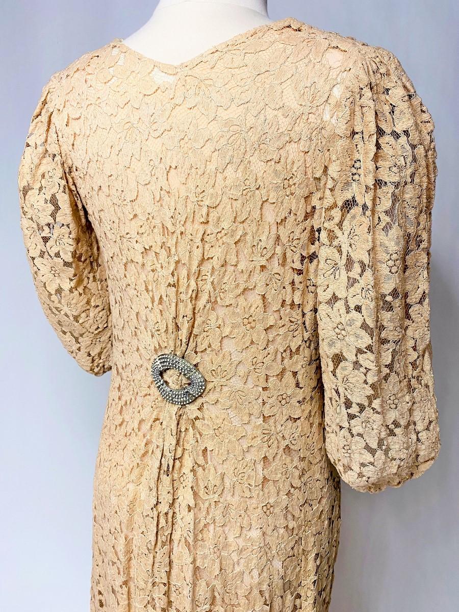 Circa 1935-1942
France or Europe

Long evening dress in cream salmon Caudry lace dating from the late 1930s or early 1940s. Loose, straight cut, V-neck, gathered at the shoulders and slightly flared at the bottom, forming a mini-train at the back.