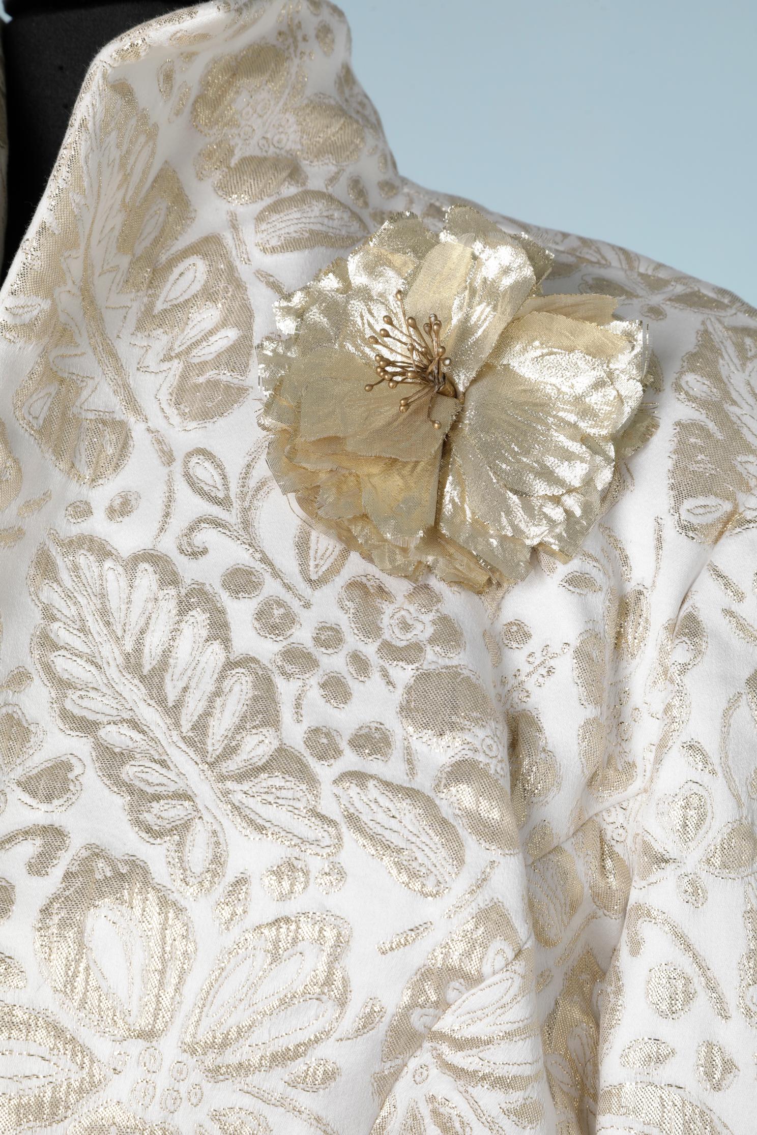 Evening dress suit in gold and off white damask. The boléro jacket has a gold lurex flower broche and the bustier dress with basque  has a gold pleated lurex bustier. 