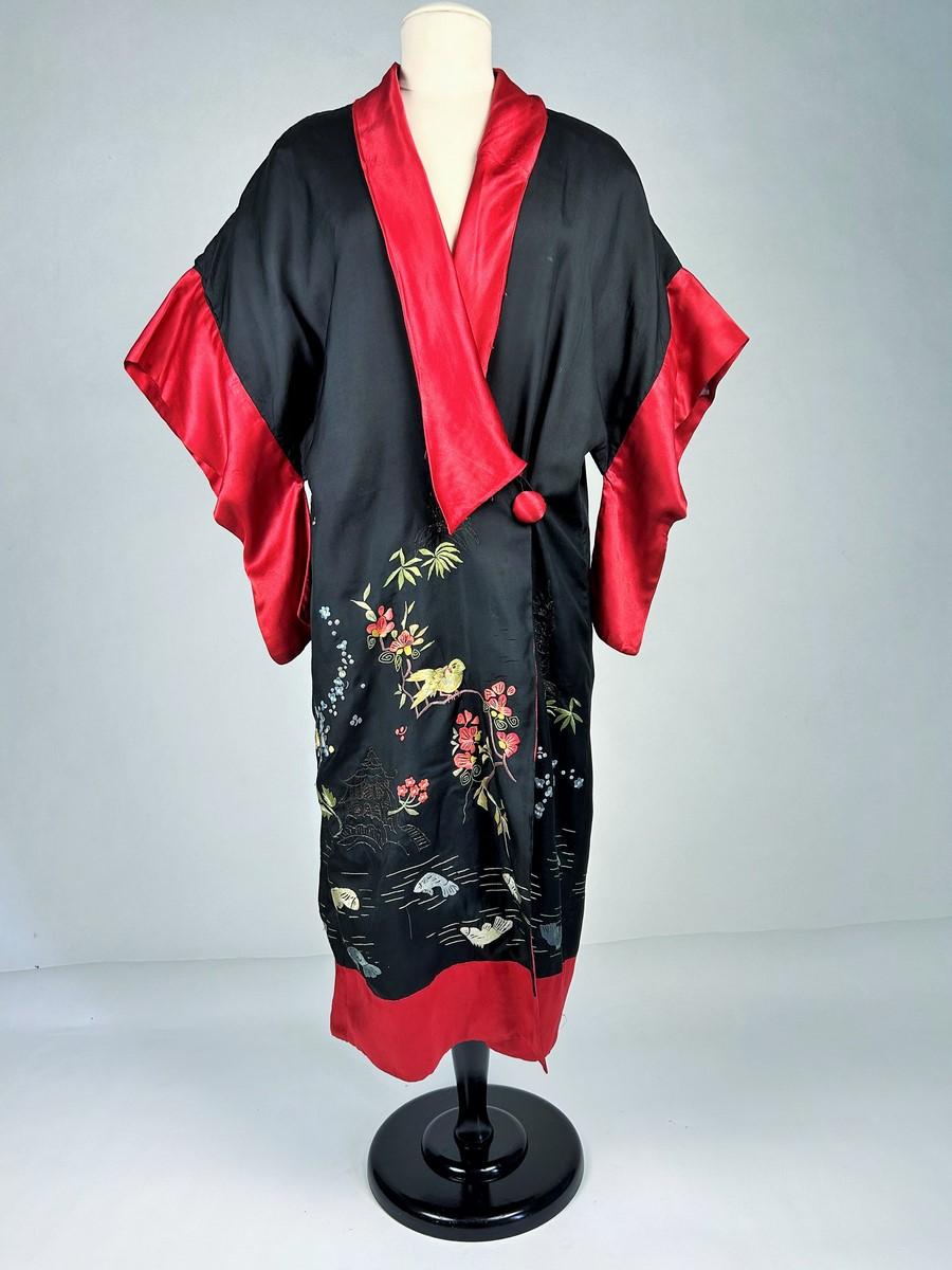 Circa 1920 -1930
France

Black taffeta evening or indoor kimono embroidered with chinoiserie and Japanese motifs, dating from the 1920s. Probably made in Asia for export to the West by famous Parisian houses such as Madame Babani. Loose fit with