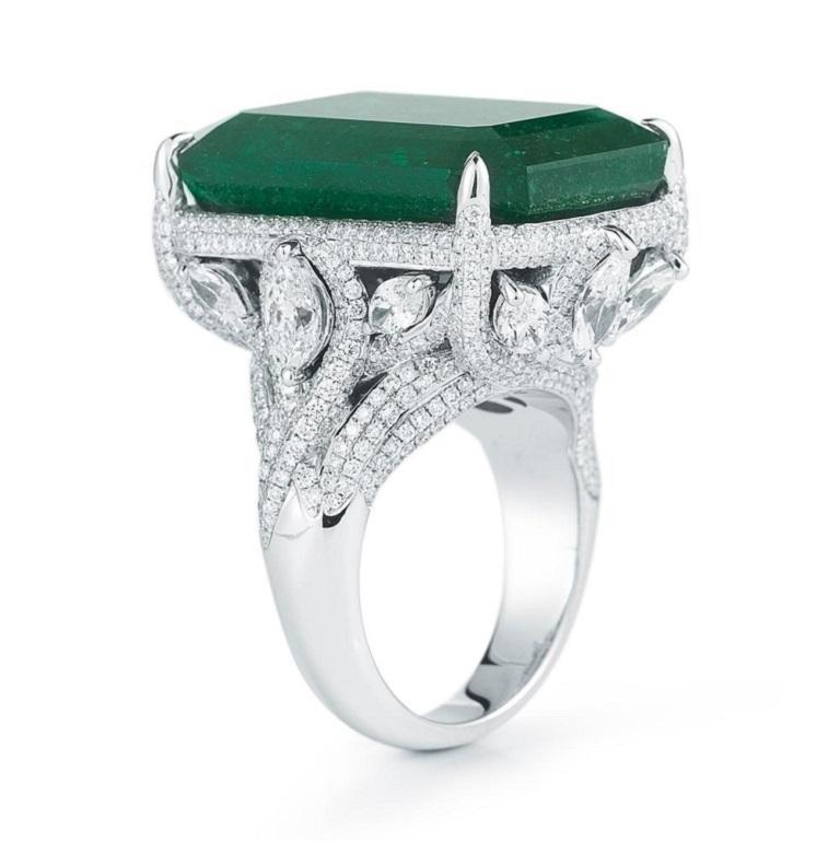 EVERGREEN EMERALD AND DIAMOND RING A sensational deep green Emerald sits in an elegant pear and round shaped diamond setting in 18K White Gold Item: # 01828 Metal: 18k W Lab: C.dunaigre Color Weight: 32.77 ct. Diamond Weight: 5.77 ct.


