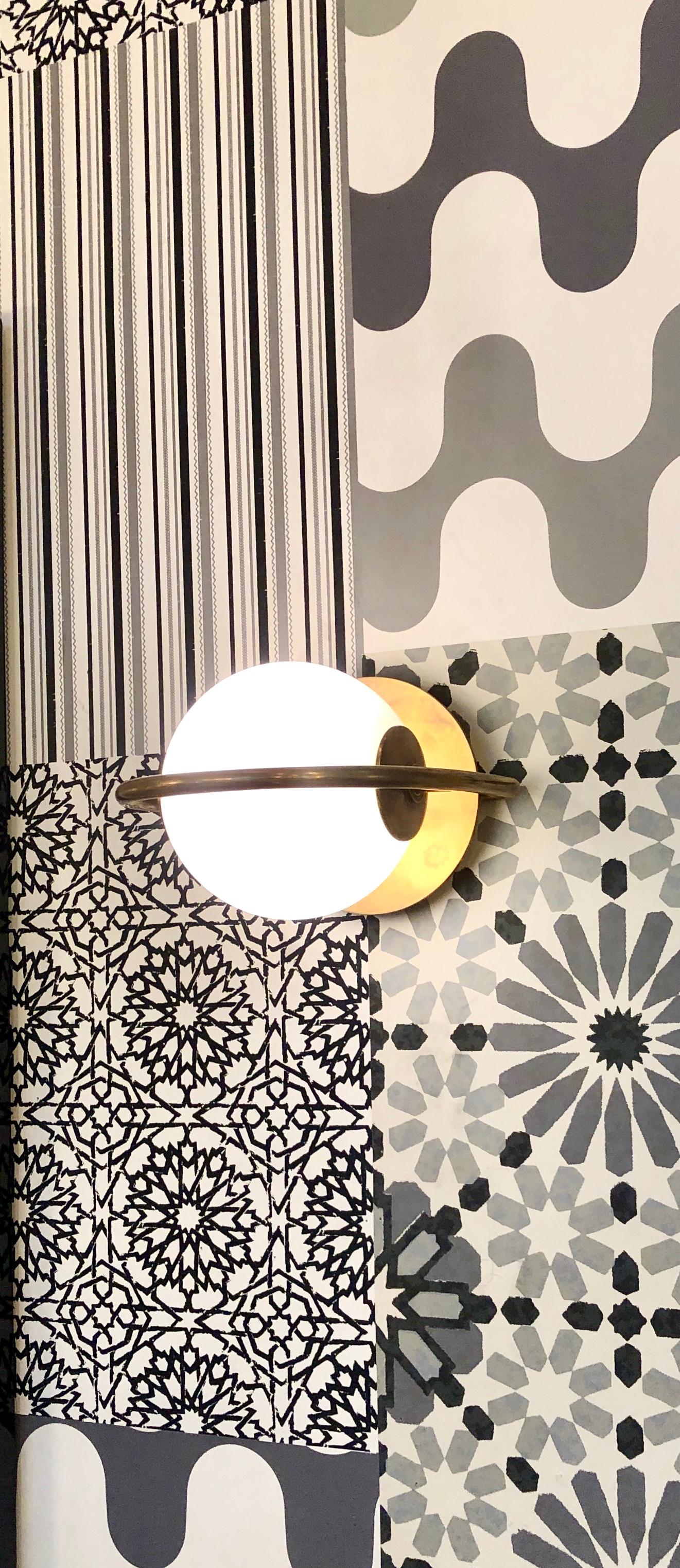 1-light wall sconce. Inspired by a pearl earring once belonging to Elizabeth Taylor, Everley exudes modern simplicity and a sense of luxury. Its asymmetry and alluring use of negative space charm in vintage brass. Everley is at once elegant and