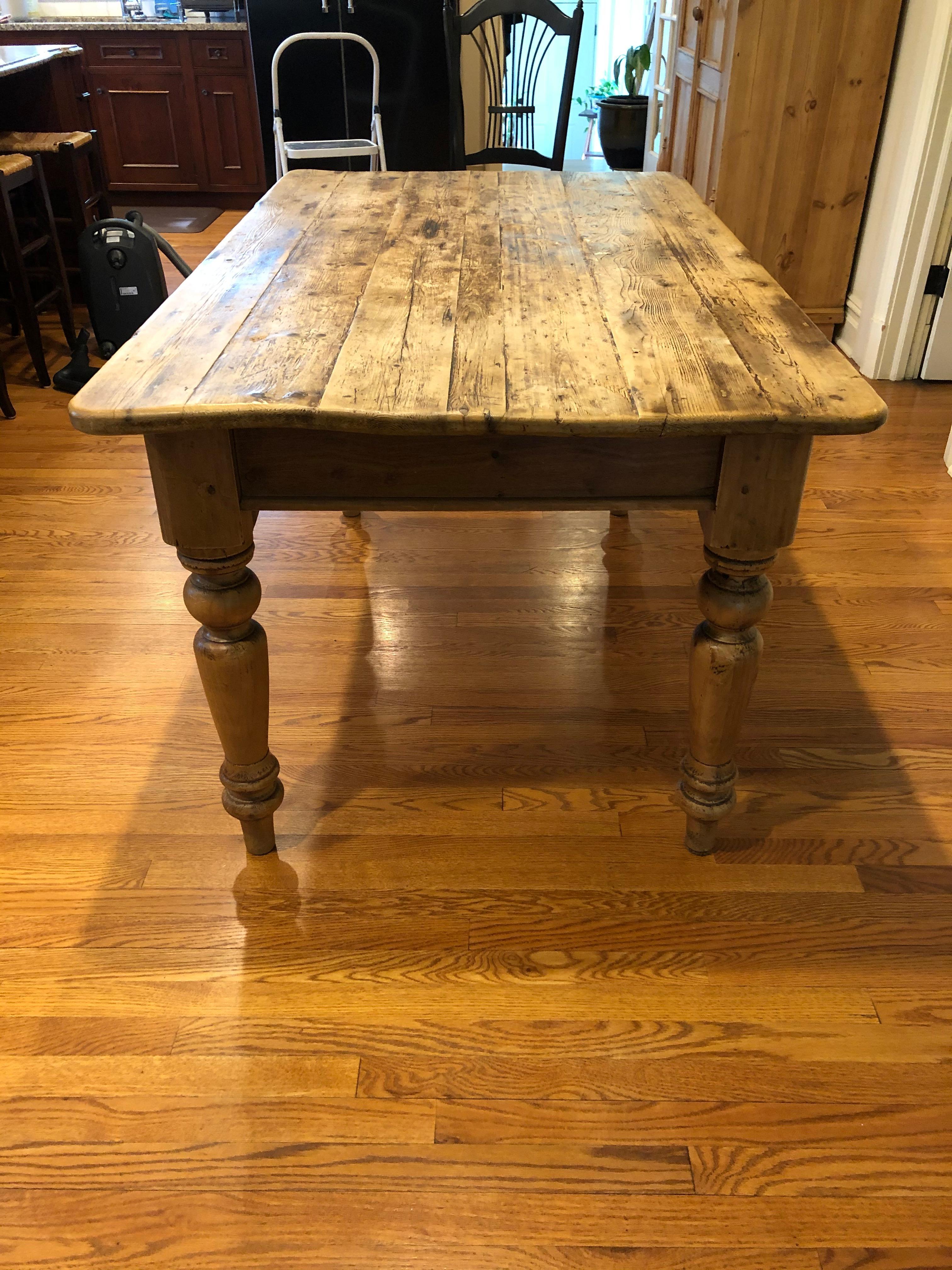Warm and welcoming antique American pine farm table having earthy rustic patina and handsome substantial turned legs. Great for a kitchen.
apron height 24.5.
