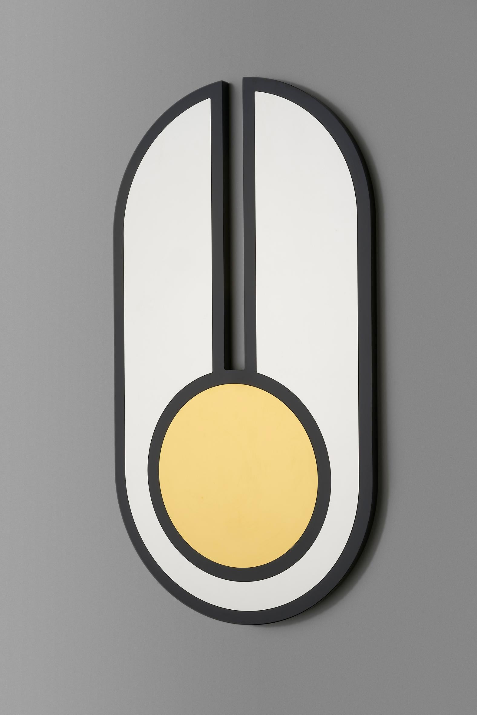 Circle and oval forms unite to create the graphic Everything is Golden mirror series. 

No. 3 features a black gloss lacquered frame inset with gold and silver mirrored stainless steel. 

3 no keyhole fixings to rear allow the mirror to be hung
