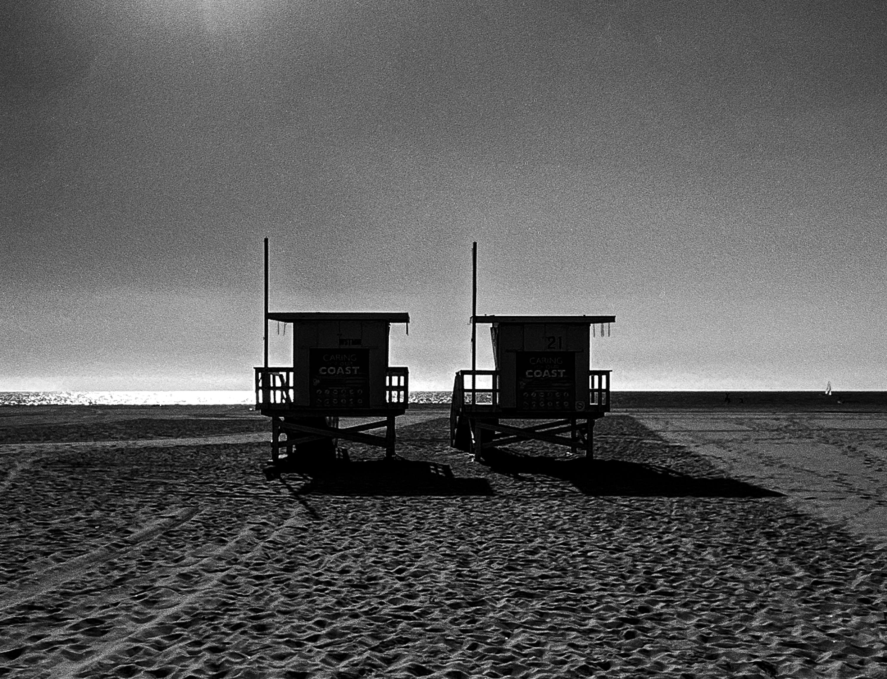 Black and white ocean beach landscape with two lifeguard towers.

Original gallery quality archival pigment print on archival paper signed by the artist.
Limited edition of 6
Paper size: 18