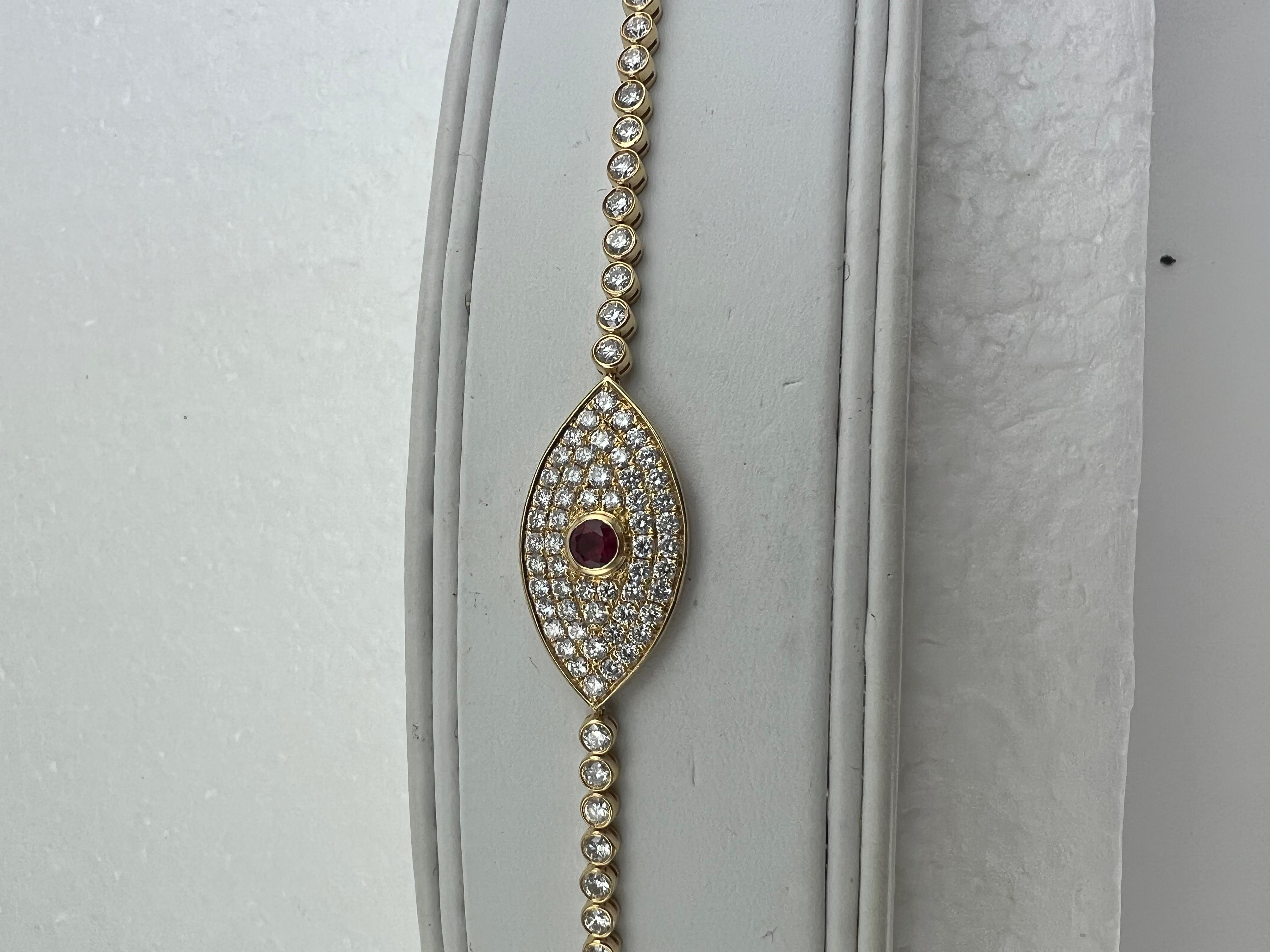 Evil eye amulet diamond ruby yellow gold

   This is a very special bracelet, well made.  It is meant to fit snugger on the wrist than other diamond bracelets so that the center evil eye amulet sits at the top of the wrist.

SPECIFICATIONS:

STONES: