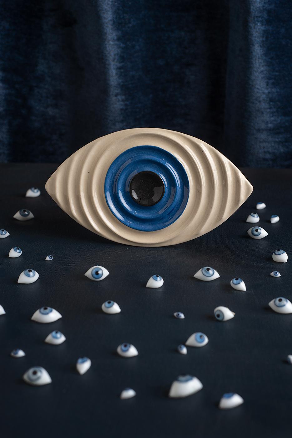 Introducing Bruci's exquisite ceramic tray in the form of an all-seeing eye, a sophisticated and modern design. Handcrafted with the utmost care and attention to detail, this unique piece follows the ancient tradition of utilizing eyes as a symbol