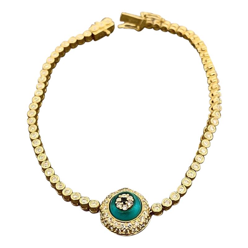 A classic evil eye! This stylish bracelet features 1.47 carats of white brilliant cut diamonds along with one black diamond used as the pupil weighting 0.02 carats. The bracelet is made in 18k yellow gold with two safety clasps for a secure