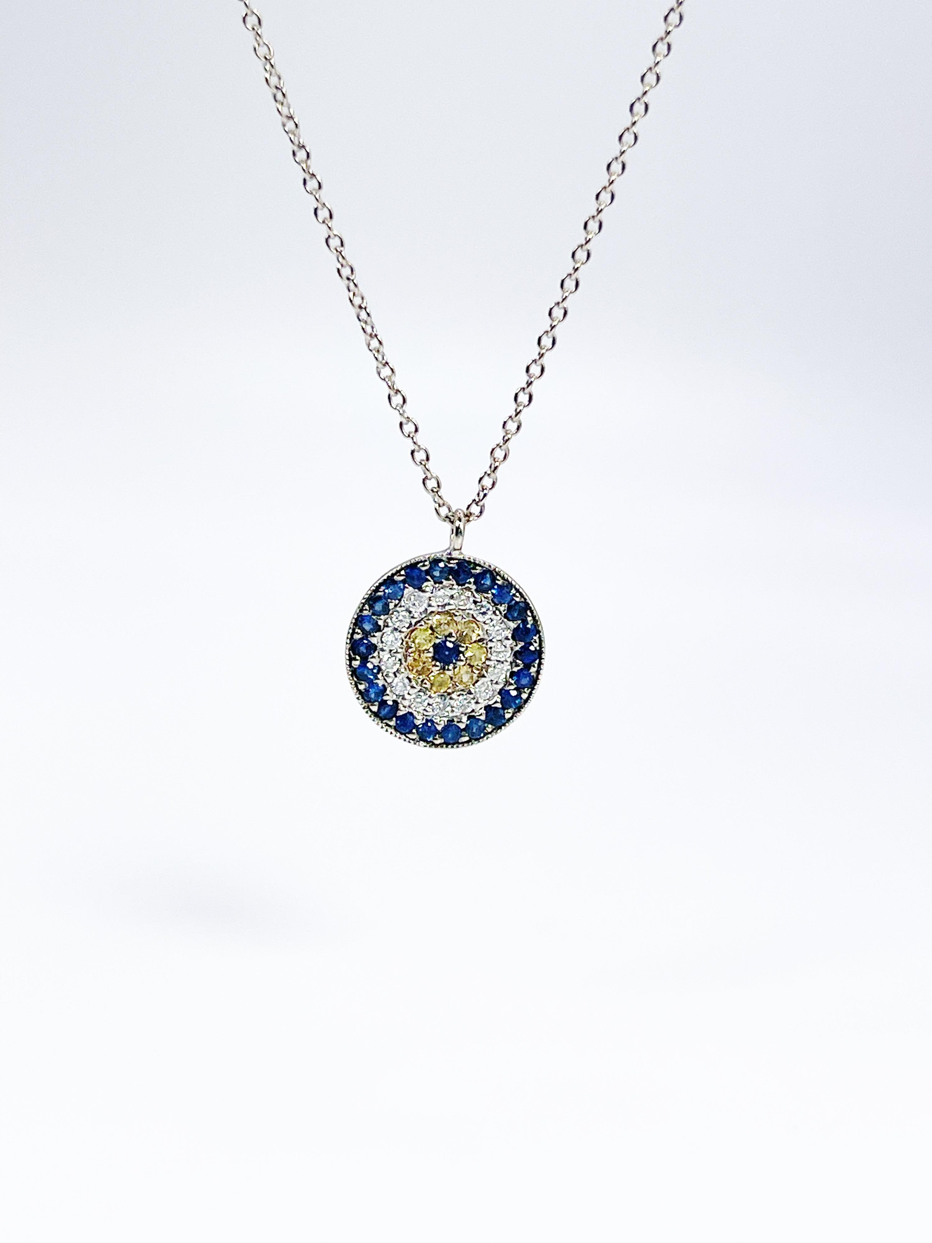 Evil eye pendant necklace made with yellow sapphire, white diamonds and blue sapphires in 14 Karat gold.

GRAM WEIGHT: 2gr
GOLD: 14KT white gold
NATURAL SAPPHIRE
Cut: Round
Color: Blue, Yellow
Clarity: Slightly Included
Carat:0.20ct

NATURAL