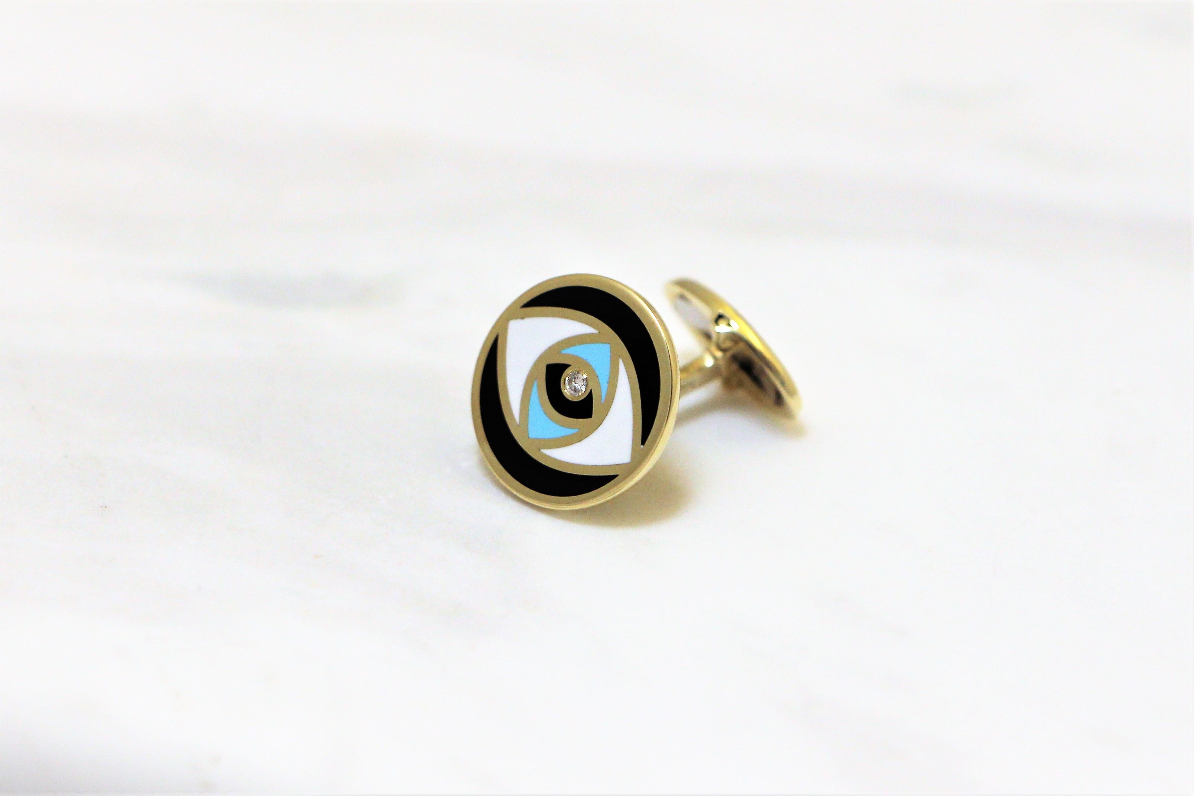 Evil Eye round cufflinks handcrafted in 14Kt yellow gold, featuring three colours of cerachrom enamel, black white and blue, that create the elegant shilouete of an eye. In the greek culture the evil eye protects the one who wears it from the