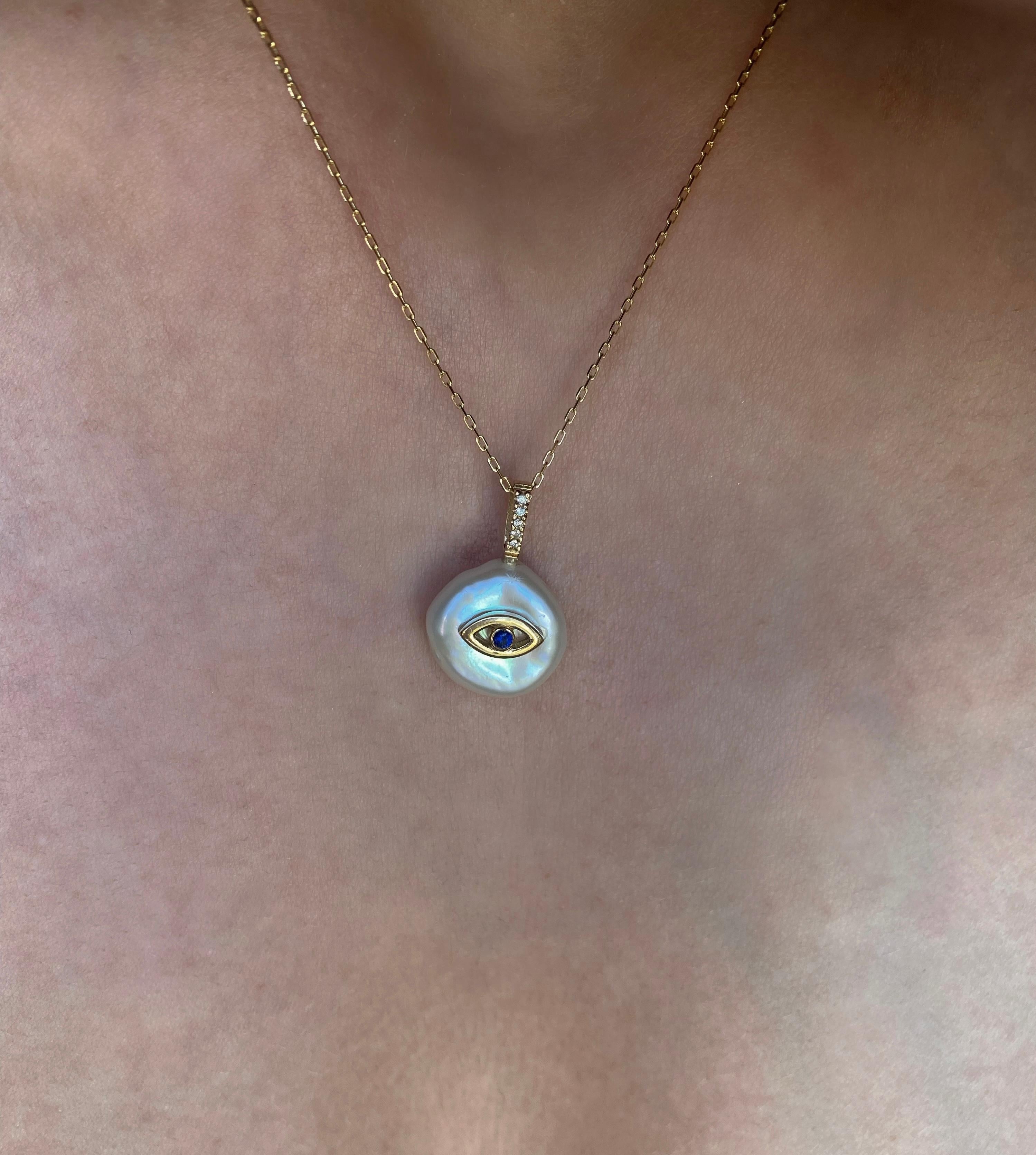 Our ‘Evil Eye Petal Necklace’, is casted from 18Karat Yellow Gold and set with natural sapphire and natural glimmering diamonds on a freshwater petal shaped pearl. It is designed to protect its wearer and ward off any negative energy. 
Each petal
