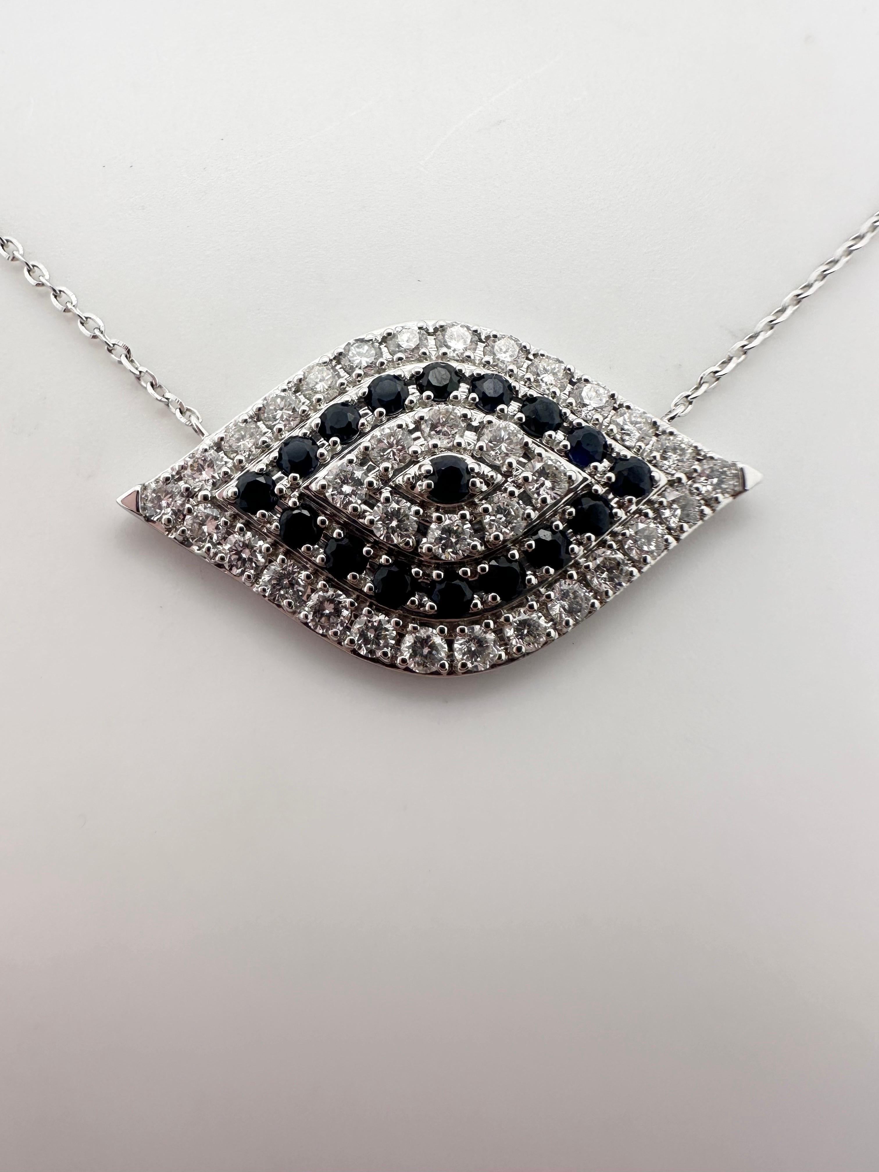 Modern pendant necklace made in evil eye design with natural sapphires and diamonds in 14Kt white gold, certificate of authenticity comes with the purchase! Chain is 18