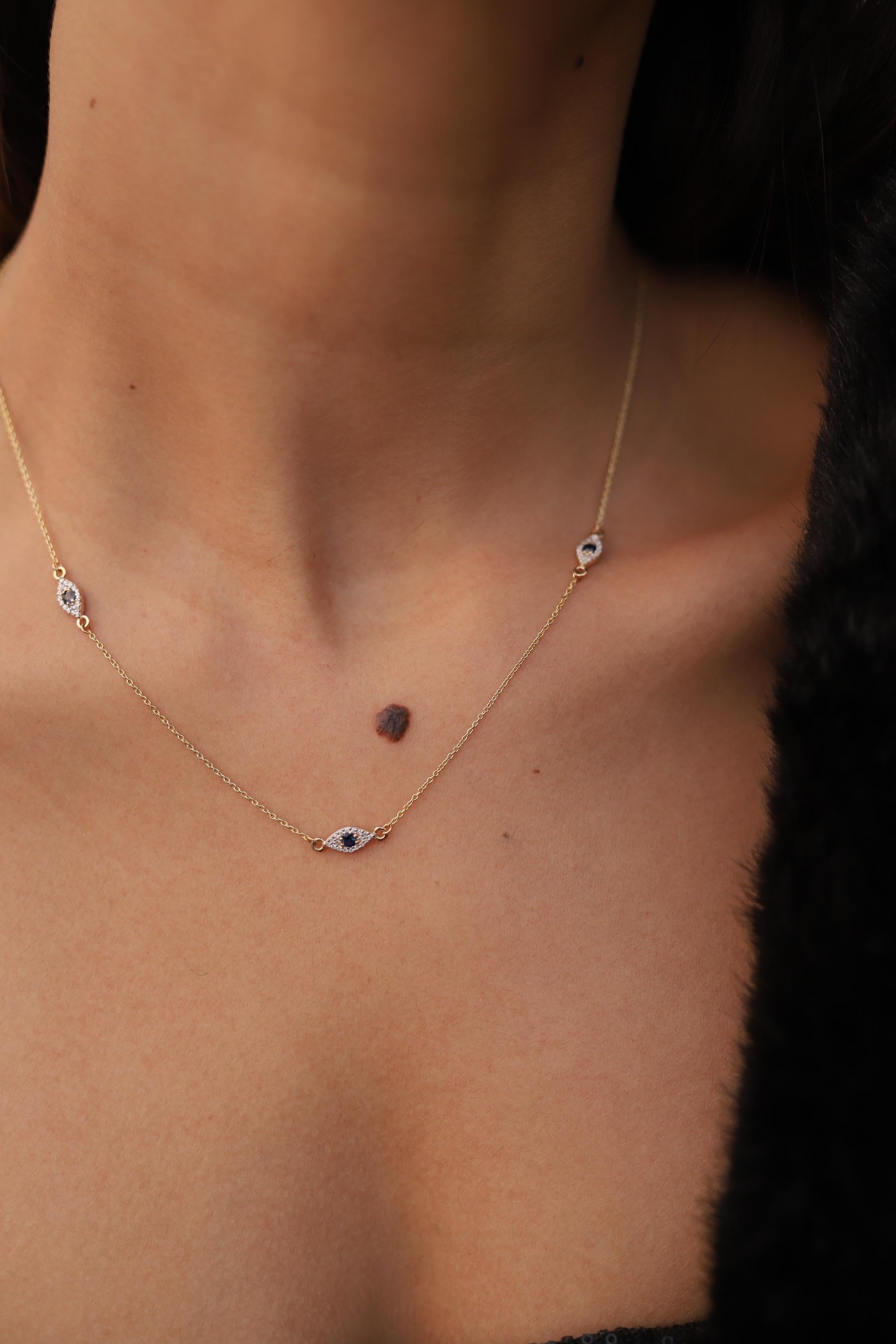 Blue Sapphire Diamond Halo Evil Eye Chain Necklace in 14K Gold studded with round cut blue sapphire and round cut diamonds. This stunning piece of jewelry instantly elevates a casual look or dressy outfit. 
Sapphire stimulate concentration and