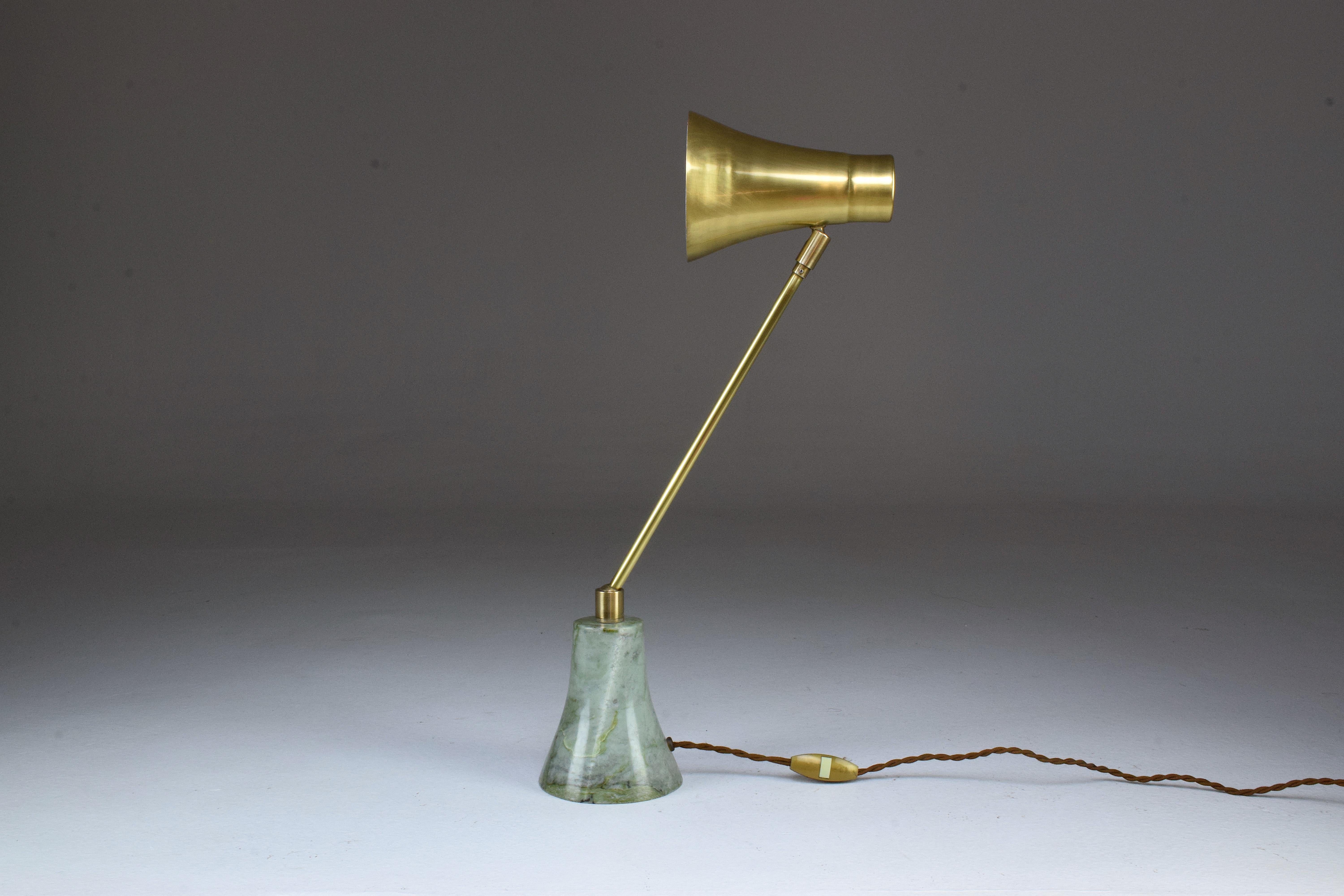 Contemporary handcrafted articulating table lamp designed in a gold polished brass stem which articulates at the base with a ball joint. The shade is designed out of brass and the base is in green Taknakht marble. 
    
The Flow collection is an
