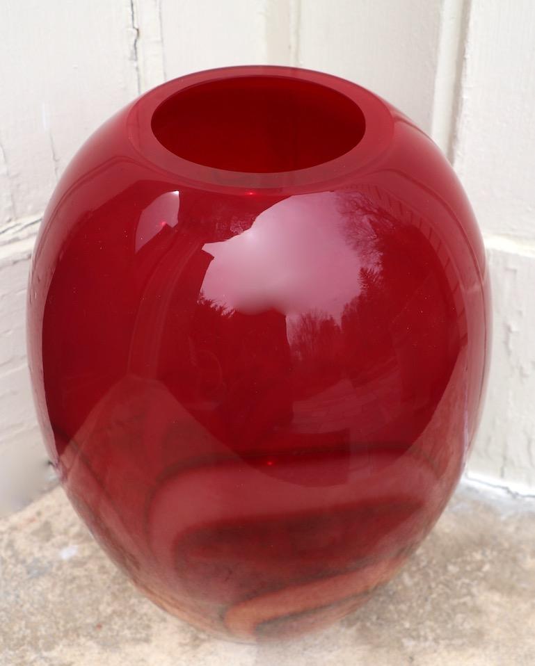 Large and impressive art glass  vase signed Waterford Evolution. This impressive vase has a red tone top with swirling organic orangish forms decorating the bottom portion of the piece. Mint condition, fully and correctly marked, clean and ready to