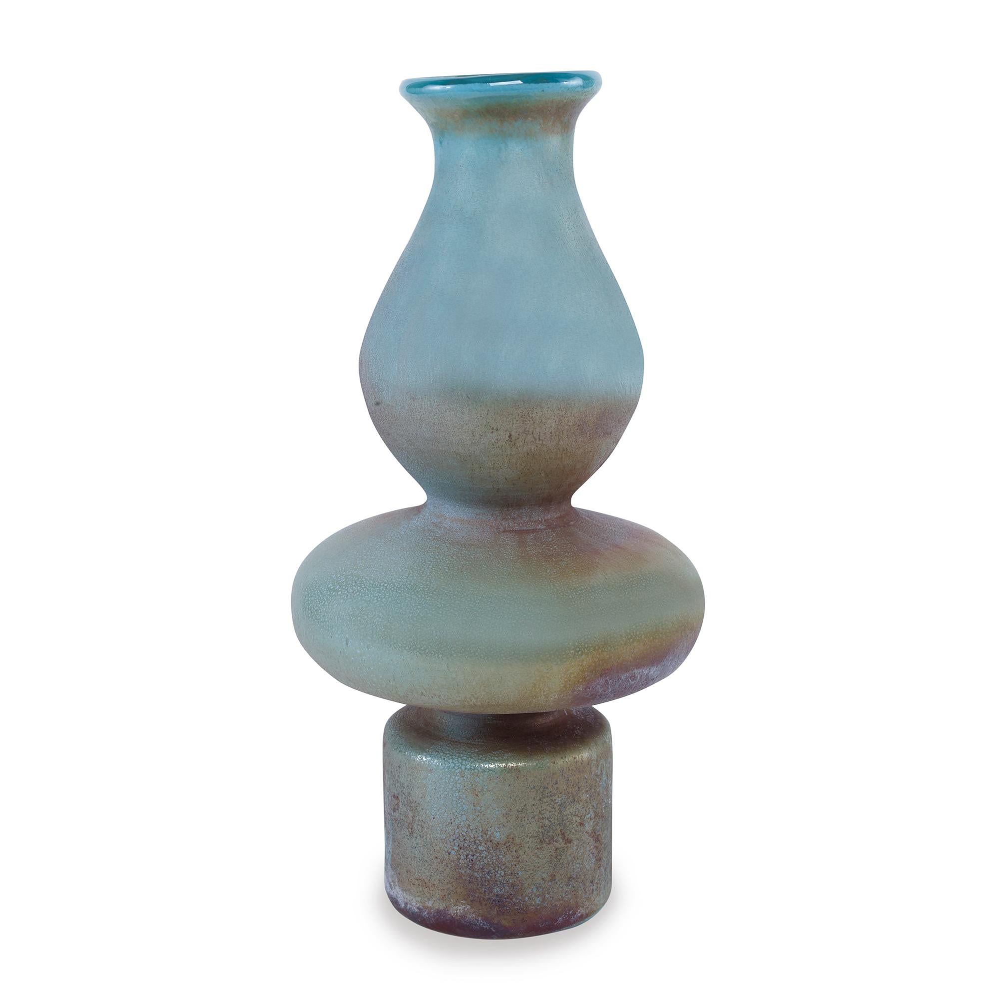 An iridescent glass vase with a 1970s inspired shape. Due to the handmade nature of this vase, variation in colors are to be expected.
 