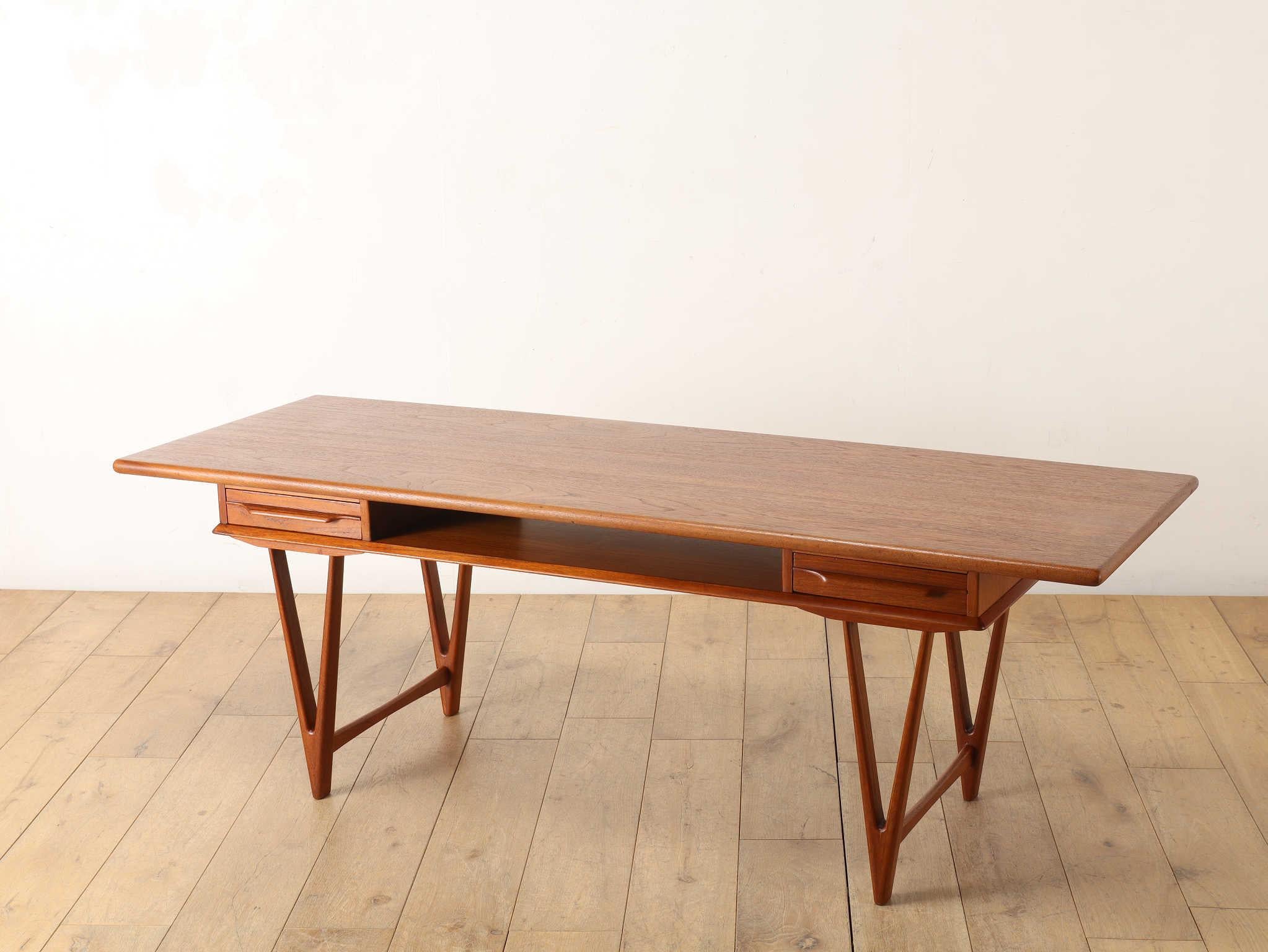 This stunning vintage coffee table was designed by renowned Danish designer E.W. Bach, a celebrated figure in mid-century Scandinavian furniture design.
Crafted from high-quality teak wood, the table features a rich, natural grain that adds warmth