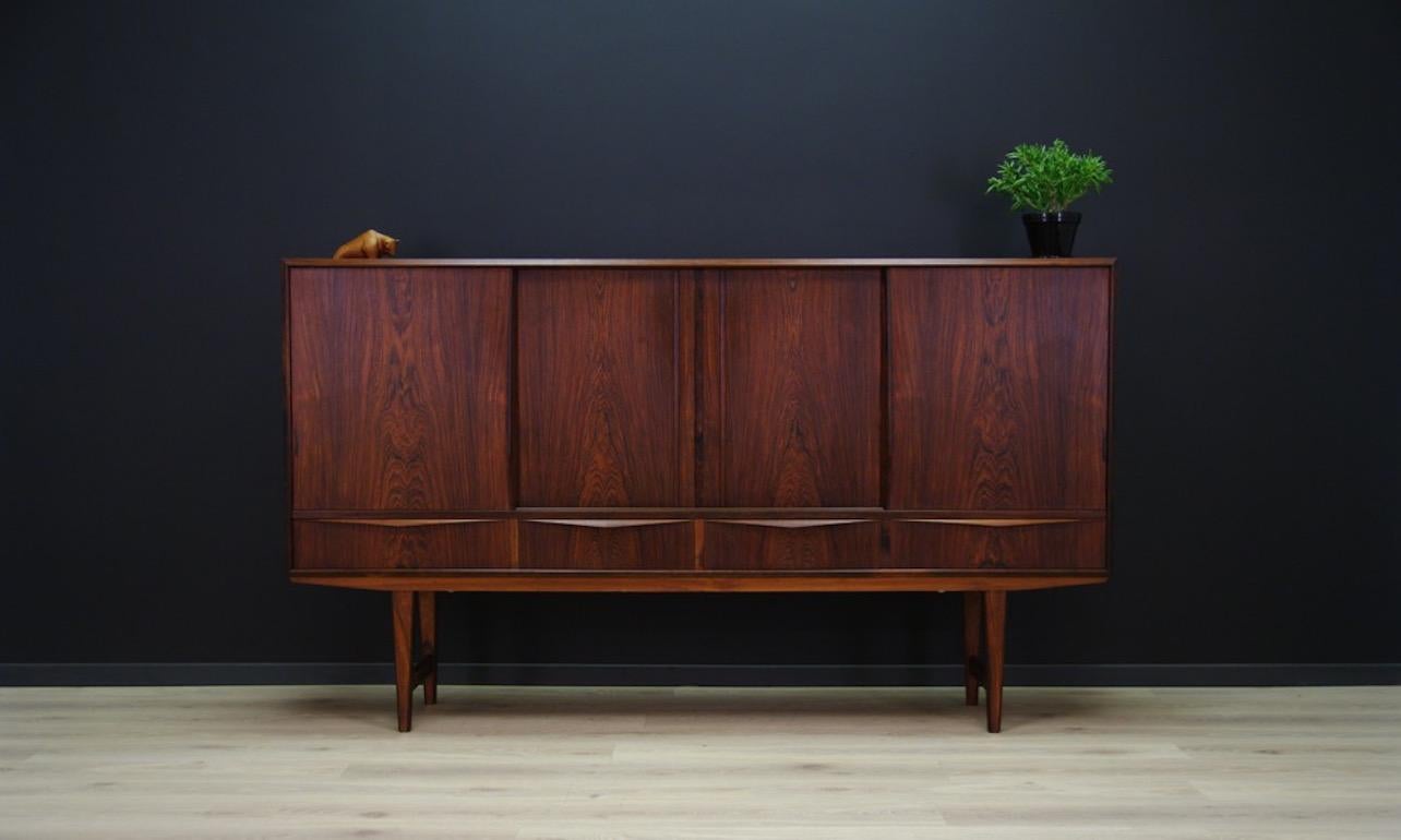 Unique highboard from the 1960s-1970s, Danish design. A Minimalist form of the E.W. Bach, produced in the Sejling Skabe manufacture. The form is covered with rosewood veneer. Legs and handles made of rosewood. A spacious interior with numerous