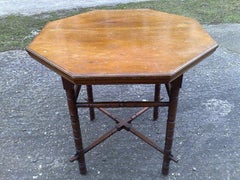 E.W. Godwin, an Aesthetic Movement Walnut Octagonal Table with Crossed Stretcher