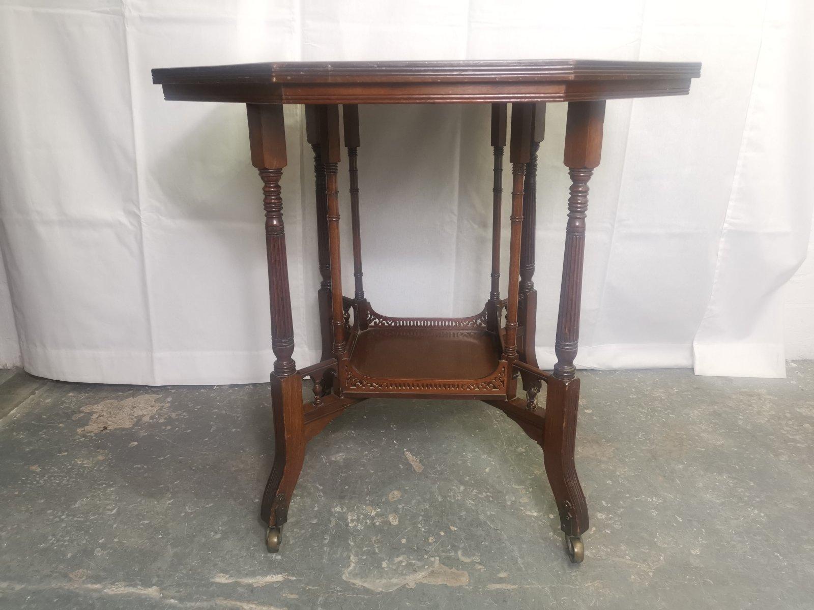 Gregory & Co, Regent St, London',
An aesthetic movement walnut centre or side table with impressed makers mark Numbered '4068'.
It has four internal finely turned supports flanked by four turned legs united by a lower shelf with pierced gallery