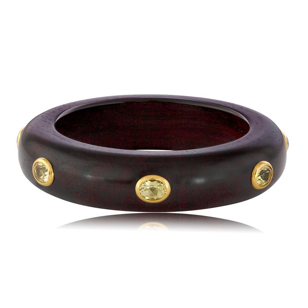 Stunning Bangle/Bracelet
The Brangle is by E.W. SCHREIBER KG
Made in Germany.
The bangle is made from Ebony Wood
The bracelet has 18K Yellow Gold Bezels
The 14.0 Carats of Light Green Citrine.
Fits up to an 8” wrist and is 0.75” wide.
The bangle