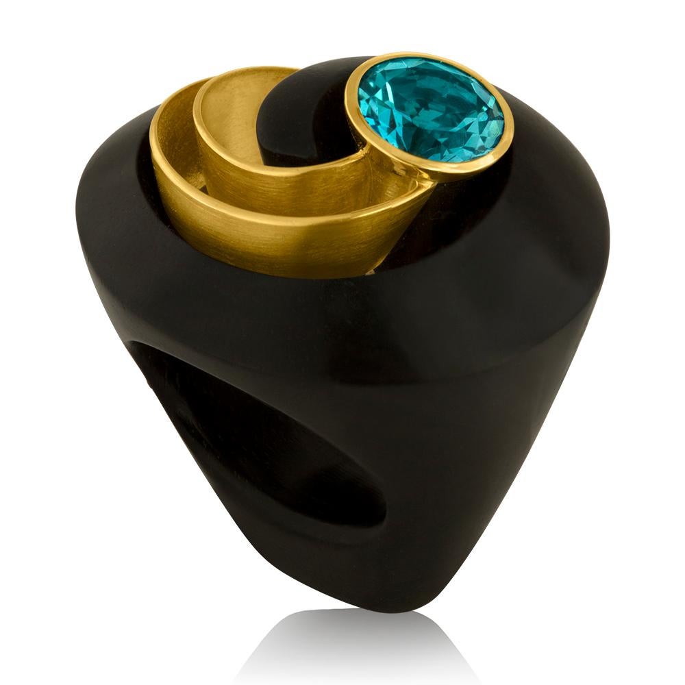 Beautiful Swirl Ring.
The ring is made from Ebony Wood
The ring is also 18K Yellow Gold
The center stone is an 8.00 Carat Blue Topaz
The ring is by E.W. Schreiber KG
Made in Germany.
Ring measures 1.75