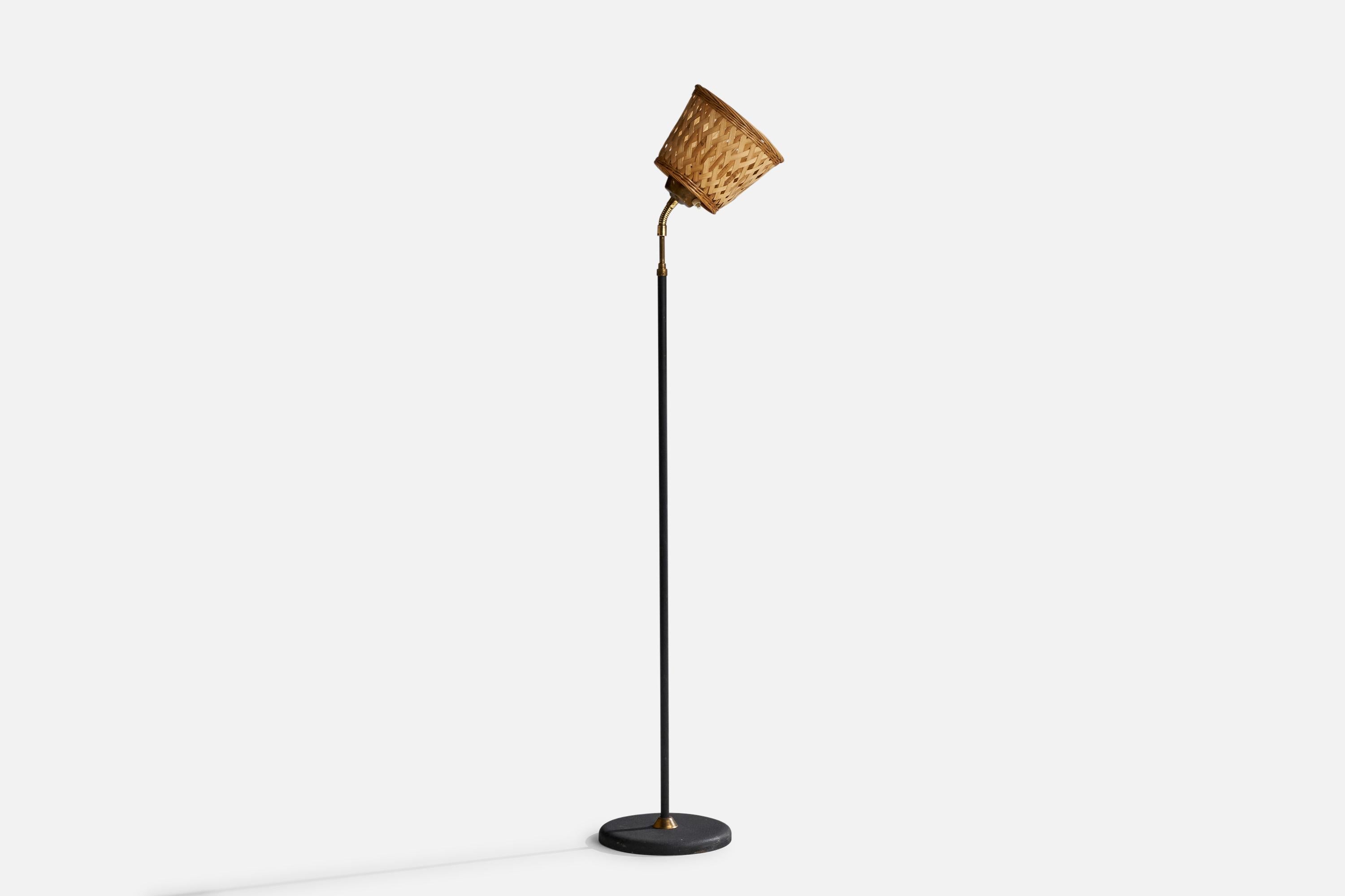 An adjustable brass, metal and rattan floor lamp designed and produced by EWÅ Värnamo, Sweden, 1950s.

Overall Dimensions (inches): 52”  H x 9.5” W x 14” D
Stated dimensions include shade.
Bulb Specifications: E-26 Bulb
Number of Sockets: 1
All
