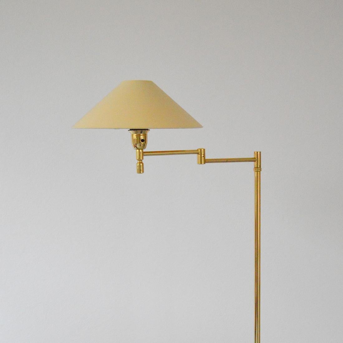 Adjustable Swedish brass floor lamp designed by Ewå Värnamo and manufactured by EWÅ in Sweden, 1970s.

Designed in the 1970s by Ewå Värnamo, this unique floor lamp is made entirely of brass and features an original fabric shade. The lamp's brass