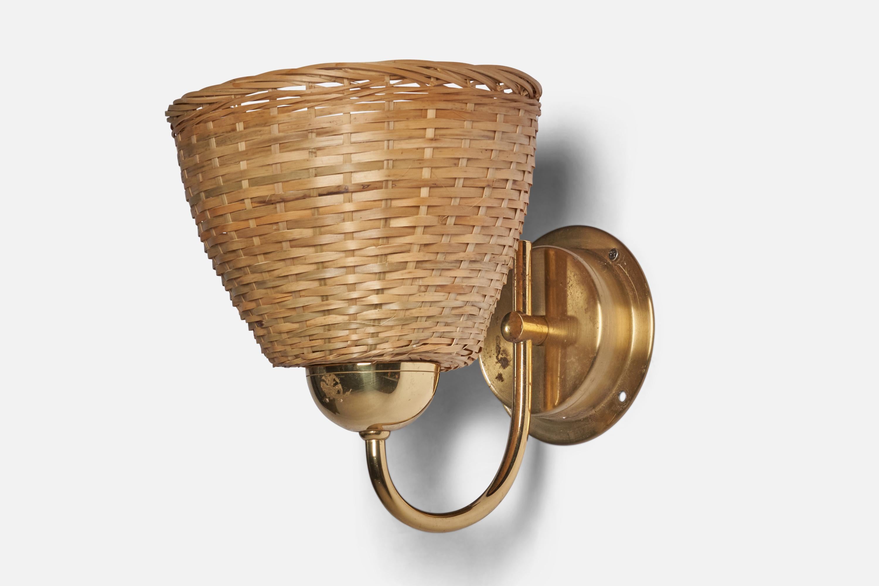 A brass and rattan wall light designed and produced by Ewå Värnamo, Sweden, c. 1960s.

Overall Dimensions (inches): 8” H x 7” W x 10” D
Back Plate Dimensions (inches): 4.2” Diameter
Bulb Specifications: E-26 Bulb
Number of Sockets: 1
All lighting