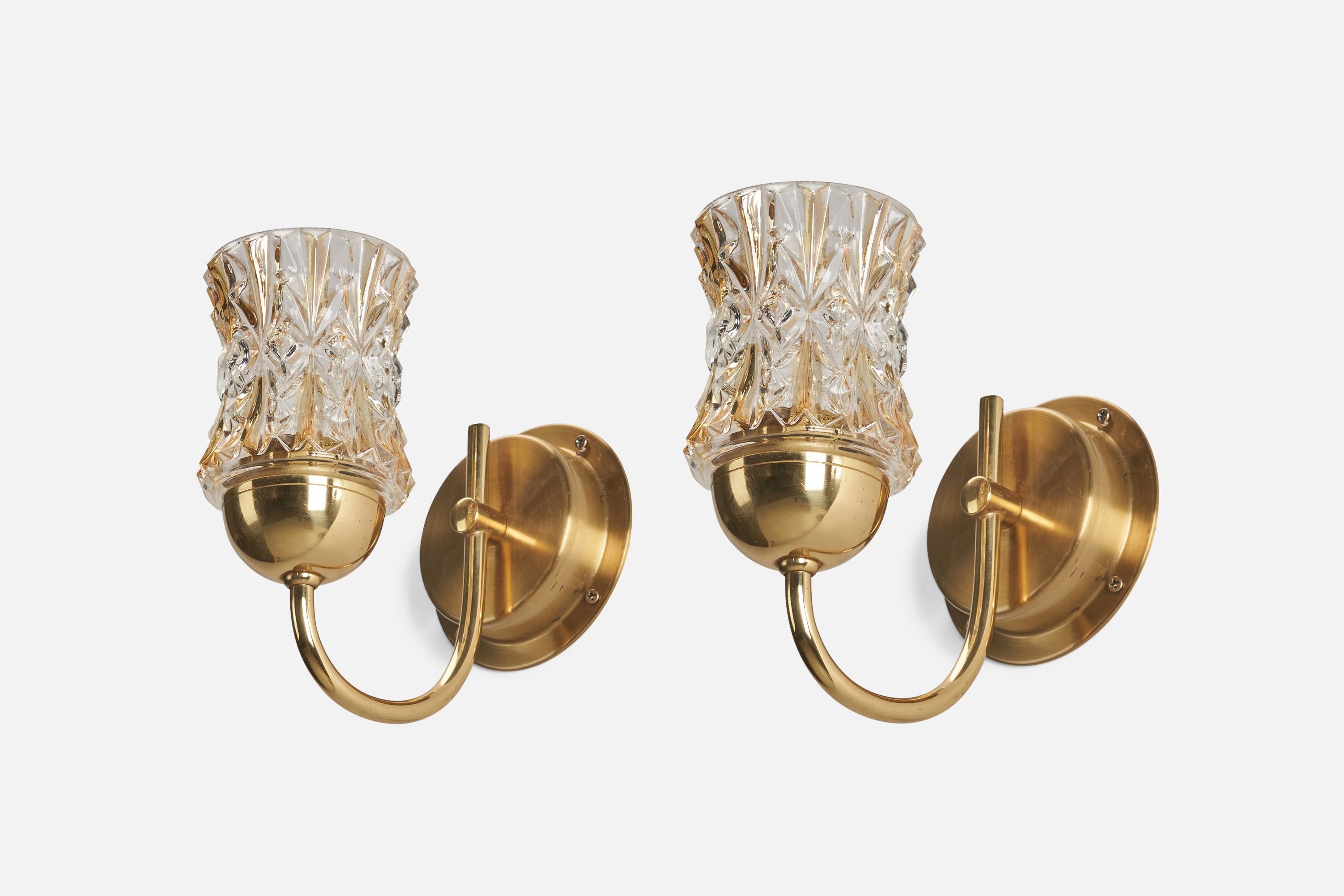 A pair of brass and glass wall lights designed and produced by Ewå Värnamo, Sweden, 1960s.